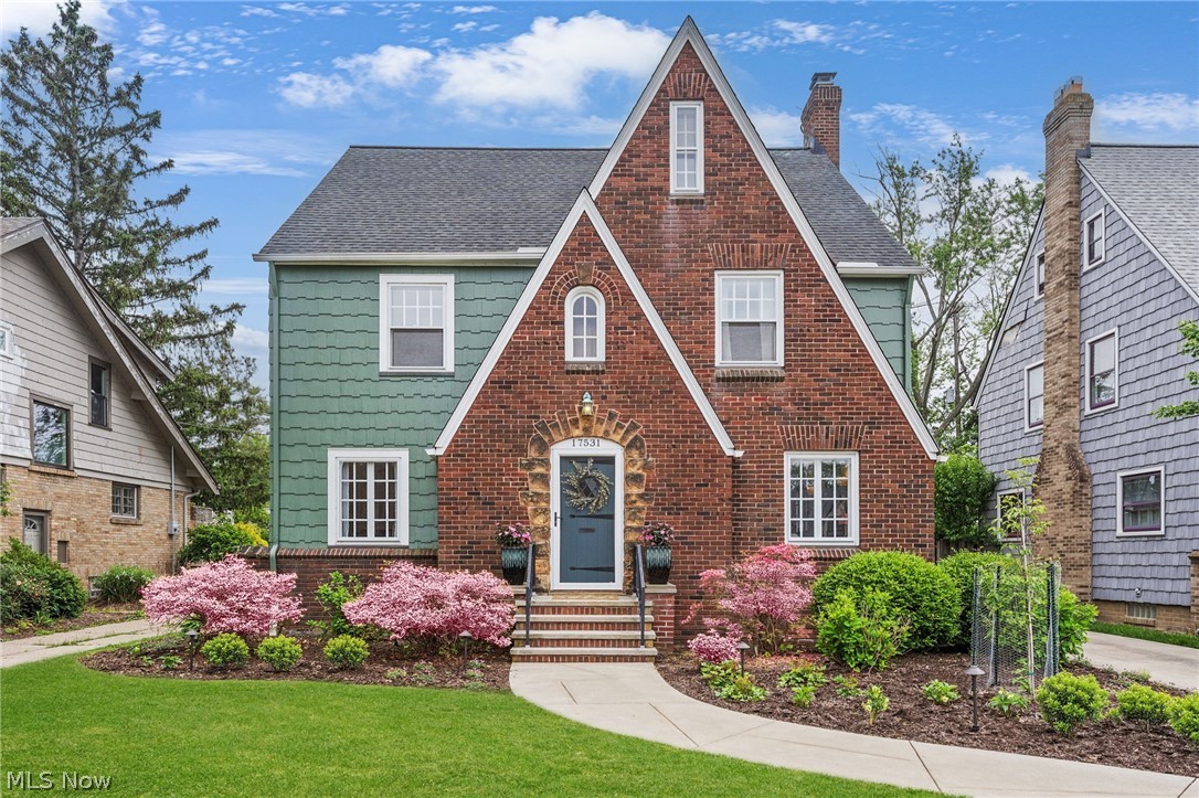 Pride of ownership is abundant in this stunning 4/5 bedroom, plus office, finished basement, and 5 total bath Lakewood Tudor. The home has a modern vibe, yet the character and traditional features, such as natural woodwork and tile foyer, have been meticulously maintained. The first floor has a bright kitchen with a built in corner breakfast nook and handy half bath. The massive dining room can hold a generously sized table for serving guests. The cozy fireplace is the heart of the home adorned by gorgeous woodwork and custom Rookwood tile in the living room, which flows beautifully to additional living space that could accommodate many possibilities such as an office, den, playroom, or exercise area. The second floor is where you will find a spacious home office and 3 bedrooms. One additional room could serve as a 5th bedroom or yet another office! There is a full bath remodeled in 2018 and a half bath attached to the master bedroom. Continuing up to the third floor suite you will find a roomy bedroom, large closet and full bath, also updated in 2018. The recreation room in the lower level has newer carpeting and charming knotty pine paneling. There is a half bath on this level. This dream home lacks for nothing inside with a thoughtful layout and living space, and an abundance of storage and closets. Last but not least is the glorious, attached, fully enclosed back porch, and interlocking paver patio that overlooks the flawless landscaping and backyard- just perfect for relaxing or entertaining. There is a built in gas grill and an irrigation station for flowers. The extra long driveway meets the oversized 4 car garage. A rare find! This highly attractive neighborhood near the Western border of Lakewood is home to this admirable property. This location is prime and close to shopping, restaurants, night life, metro parks and numerous other amenities with quick and easy access to I-90.