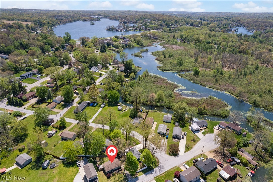 HELLO DARLING! Welcome home to 316 Hohman Ave in Portage Lakes. This property has a perfect location: close to the lakes, highway access and many amendities (including ice-cream within 1/2 mile). The home boasts 960 square feet on the first floor including large living room space + corner windows, *fun* eat-in-kitchen, three bedrooms that share the full bath. Lower level includes a huge rec room offering an additional 546 square feet. There is access to the fully fenced in backyard from the basement walk-out. Generous sized lot + shed, all yours. The front deck offers another cozy space and views of Long Lake. Mechanical improvements are extensive including: freshly painted kitchen cabinets,roof/siding/gutters (2024), HVAC (2023), new well lines (2022), kitchen appliances (2021), tons of trees removed and added fenced in backyard. Schedule your showing today!