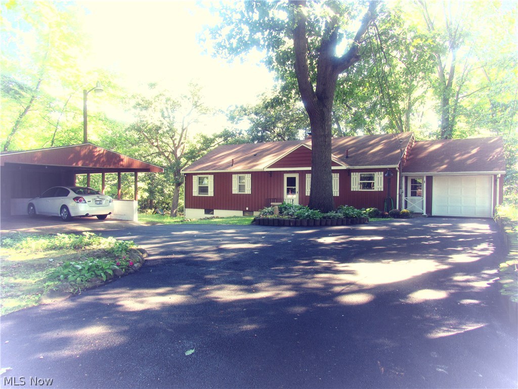 Charming redwood sided ranch with 3/4 bedrooms, 2 full baths, on .9192 acre wooded lot.  New asphalted driveway leads you to your 20x24 carport and 1 car attached garage with storage above.  This unique home has knotty pine accents throughout, including pocket doors for privacy as needed.  Woodburning fireplace accents the living room and second fireplace in expansive walk out rec room then onto enclosed patio for entertaining.  Oversized utility laundry room of 12x25 offers great storage plus additional rec room joining- useful for exercise, office or hobby craft- possibly even fourth bedroom! Not to forget additional lower utility room 12x12 to use as you like.  Be sure to schedule your showing, this charm will not last!!