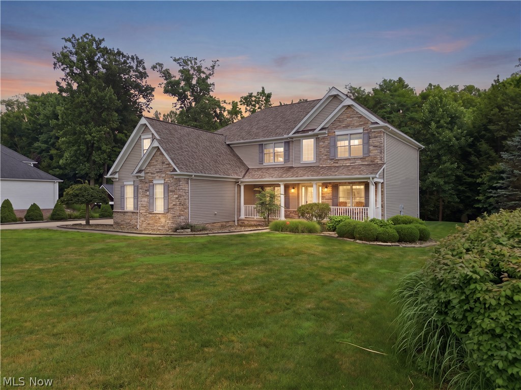 Luxury, privacy, and exceptional entertaining define this beautifully maintained home offering over 4,600 finished square feet on a picturesque wooded lot. Thoughtfully updated throughout the past several years, this home blends timeless craftsmanship with today's most desirable finishes and amenities.
An inviting covered front porch and timeless curb appeal welcome you inside, where a soaring two-story foyer opens to a dramatic great room filled with natural light. The spacious kitchen serves as the heart of the home, featuring new granite countertops, all newer stainless steel appliances, abundant cabinetry, generous prep space, and an open design perfect for everyday living and entertaining.
The walkout lower level transforms this home into an entertainer's dream, featuring a dedicated home theater wired for surround sound with projector and 110-inch screen, a full second kitchen with KraftMaid soft-close cabinetry, fitness room, and expansive recreation space ideal for entertaining, multigenerational living, or overnight guests.
Outdoor living is equally impressive with a large composite deck and pergola overlooking mature woods that provide remarkable privacy and beautiful views throughout the seasons. Whether enjoying morning coffee on the welcoming front porch or relaxing on the back deck, every outdoor space invites you to slow down and enjoy your surroundings.
Significant recent improvements include a new roof (2023), beautifully renovated walkout lower level, updated bathrooms, new granite countertops, all newer stainless steel appliances (2024), handcrafted barn-style sliding door with built-in coffee bar, the majority of the interior professionally painted (2024), and new carpet on the stairs, landing, and home office (2026).
Move-in ready and meticulously maintained, this exceptional home offers luxury, privacy, outstanding entertaining spaces, and one of Ellison Creek's most desirable settings.