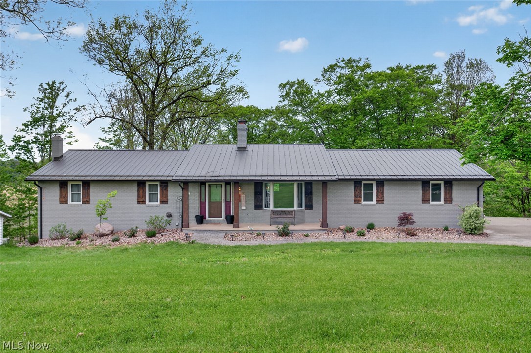 Beautiful Updated Four-Bedroom Brick Ranch on 2 Acre Country Lot! Updated kitchen with granite countertops, built -in stove top, and double oven. The kitchen opens to the dining room and the front study. Updated full main-level bath with a walk-in shower. Owners' suite with private bath. Nice foyer with an open staircase to the lower level. Full walkout basement with bar area, family room, and access to the large rear patio area, perfect for entertaining! Concrete drive, stamped concrete areas! Located close to town with a country feel! Recent updates include roof '23, well and pressure tank '21, electric service and breaker box '25, bathroom '25, floors '24, and deck '20.