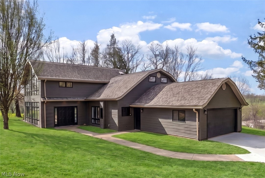 Welcome to a truly exceptional, fully remodeled home offering over 3,100 SqFt of beautifully designed living space on 3.3 acres in the highly desirable East Muskingum School District. Step inside to a grand entryway that opens into a stunning living room, where floor-to-ceiling windows flood the space with natural light and showcase the picturesque views. A wood-burning, floor-to-ceiling stone fireplace adds warmth to the room, while direct access to the side deck creates seamless indoor-outdoor living. Just off the living room, a breathtaking sunroom wrapped in windows offers the perfect space to relax and take in the beauty of the property year-round. The completely remodeled fully applianced kitchen is a showstopper, featuring quartz countertops, a spacious island, abundant cabinetry —perfect for both everyday living and entertaining. The adjacent dining room includes a patio door leading to an expansive deck, ideal for hosting or simply enjoying the sweeping views. The main floor also offers a versatile flex space—perfect for a home office, den, or playroom—along with a convenient half bath, laundry room, and utility room with additional storage. A unique dual-entry staircase adds both character and functionality to the home’s thoughtful layout. Upstairs, the home continues to impress with three spacious bedrooms, including a luxurious primary en-suite featuring vaulted ceilings, a dramatic wall of windows, a walk-in closet, and a spa-like bath complete with a jacuzzi tub, walk-in shower, and dual vanity with granite countertops. A guest en-suite with its own full bath provides comfort and privacy for visitors, while an additional bedroom and full bath complete the upper level. The property also includes a 2-car attached garage, adding everyday convenience to this incredible home. This rare property perfectly blends modern updates, and architectural character!