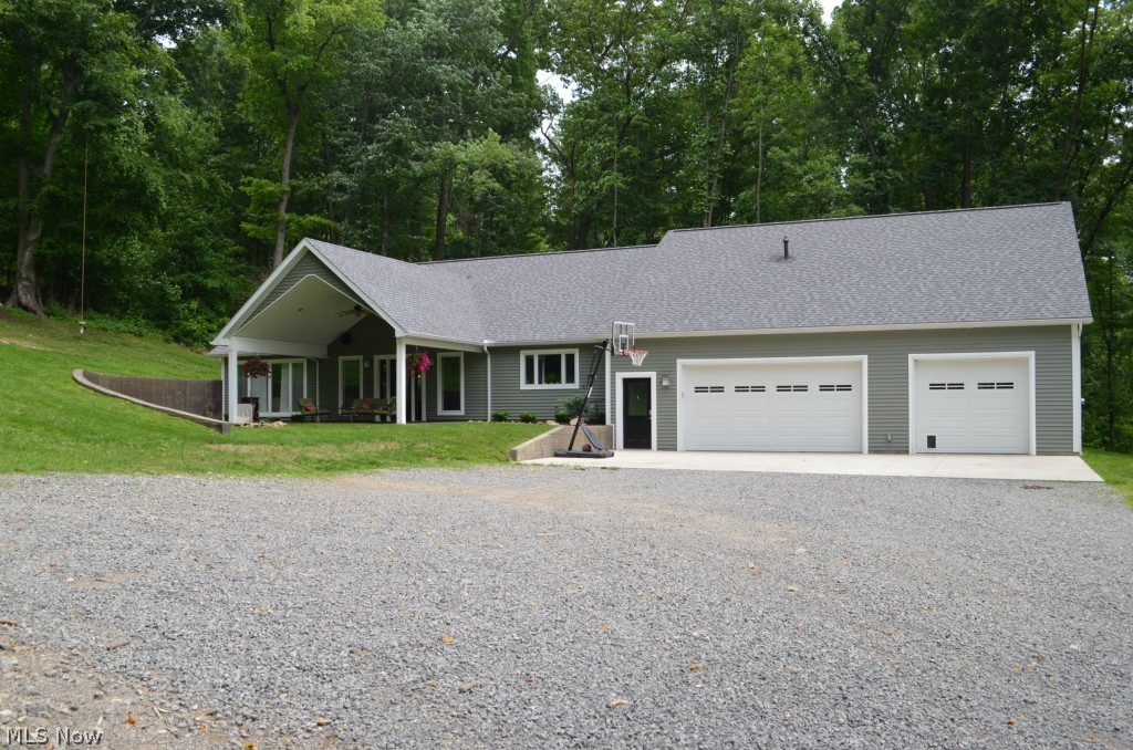Transitional style home on 2 acres outside of Winesburg. Main floor features a chef's kitchen with commercial appliances and custom cabinetry. Open concept first floor with master suite, laundry, and large walk in pantry. The home has in-floor heat and forced air gas heat with C/A, central vac. Second floor features family room, 2 more bedrooms, bath, and a studio apartment complete with kitchen and full bath. 2x6 construction, blown in insulation, Anderson windows, wired for sound. Front porch is plumbed for outdoor grill. 40x44 Mechanics dream garage with in-floor heat, 11' ceiling, Jib crane, and built in workbench.