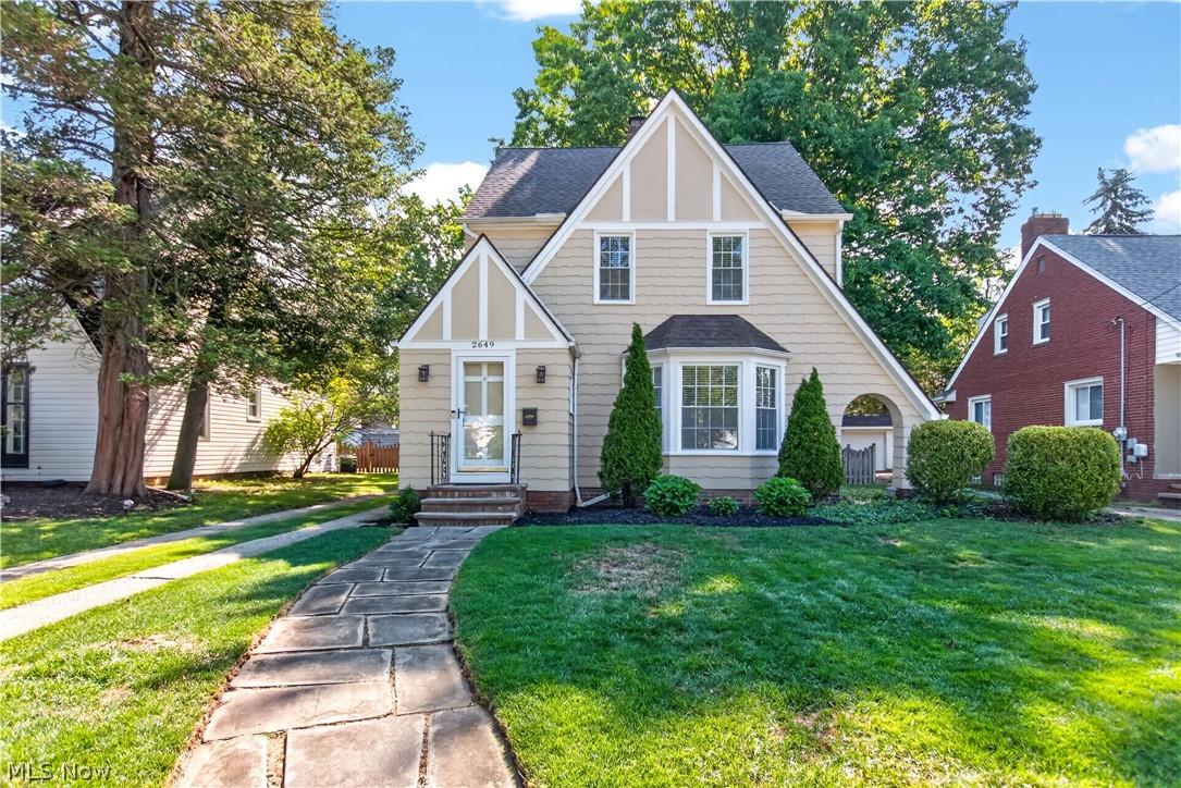 Welcome to 2649 Lakeview Avenue — a picture-perfect Tudor that feels like home the moment you arrive. Curb appeal is exceptional with freshly repainted wood shake siding (2024), striking angled rooflines, mature shade trees, and a welcoming walkway to the front door. The fully fenced backyard offers privacy and plenty of room for play, entertaining, or simply relaxing. Take note of the oversized 2-car garage built in 2020, providing an impressive amount of space and modern convenience. Inside, classic character shines throughout this well-maintained River home. A convenient vestibule with two closets provides an ideal drop zone for coats and shoes. Hardwood floors greet you in the spacious living room, anchored by one of two fireplaces. The open-concept kitchen and dining area features a breakfast bar, pendant lighting, and a large walk-in pantry perfect for overflow storage and additional counter space. All appliances stay, so you can move in and start cooking right away. Upstairs you’ll find three bedrooms, including a generous 13’ x 11’ primary. The full bathroom on this level has been recently refreshed with an updated shower, vanity, and mirror. A versatile third-floor bonus space (adding over 200sq ft) offers flexible options — easily convertible to a fourth bedroom, home office, or playroom. The partially finished basement is perfect for movie night, game night, or a place for some peace and quiet. This area features the second fireplace, recessed lighting, and durable LVP flooring. Just steps away you’ll find the laundry area and a conveniently-located half bath. Recent updates include a newer electrical panel and wiring, vinyl replacement windows, and a security system — which, along with a one-year home warranty, will give you complete peace-of-mind. This is a rare opportunity to own a charming, updated Tudor in Rocky River. Schedule your private showing today and imagine making this house your home!