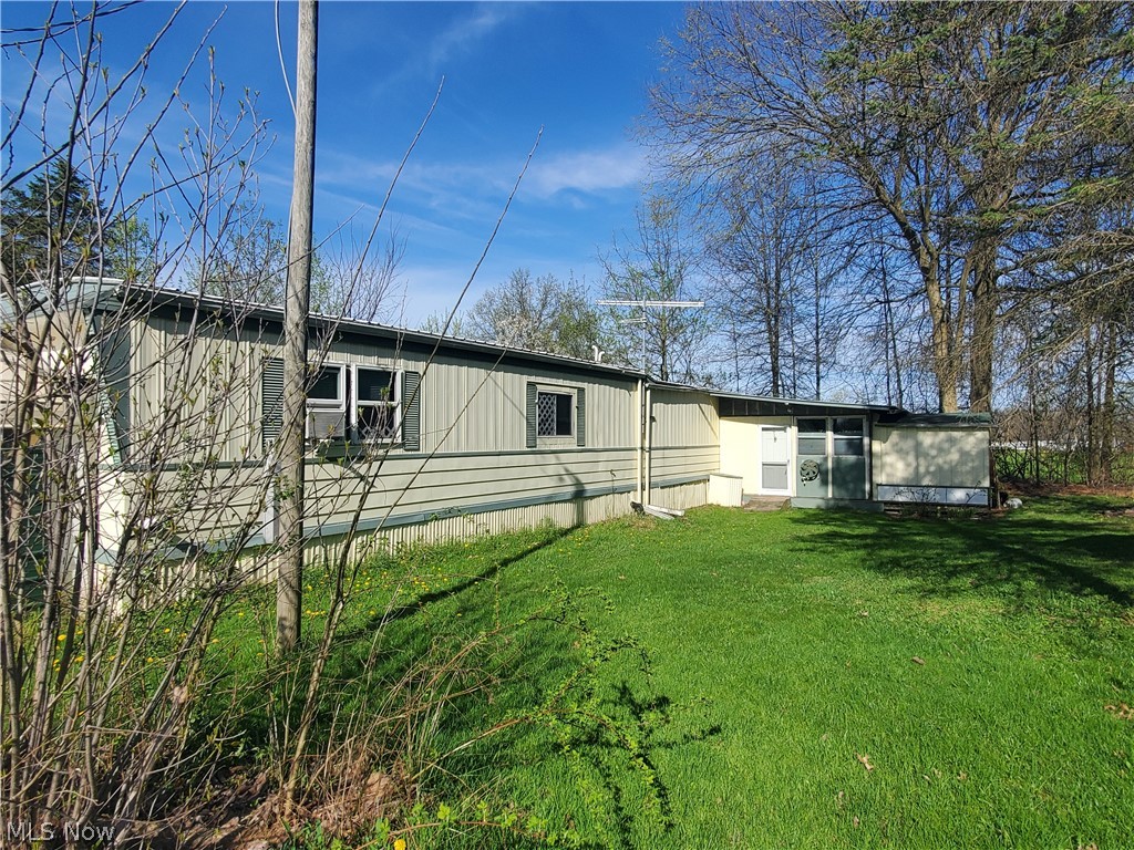 Nice mobile home community in Woodridge Schools!  This home has many unique features including an attached 2 car garage,  three season sunroom, workshop and plenty of closet space.  Spacious living room with gas fireplace is open to the eat in kitchen - all appliances convey with the home (including washer and dryer).  One bedroom with an office or 2 bedrooms and 1 full bath.   Amazing addition could be used as a workshop or exercise room/office.  This home has many windows, which creates an abundance of light.  New roof - 2021, Furnace and Hot water tank are within 5 years, heat tape was replaced in December, 2023, new plumbing and toilet installed April, 2024.  There are two dog runs, 1 at each entry door.  This home is being sold "as is".
Monthly lot rent of $385 includes common area maintenance, currently water and trash.  They are in the process of installing water meters - the residents will not be billed on usage until at least July or August (per Regional Manager).