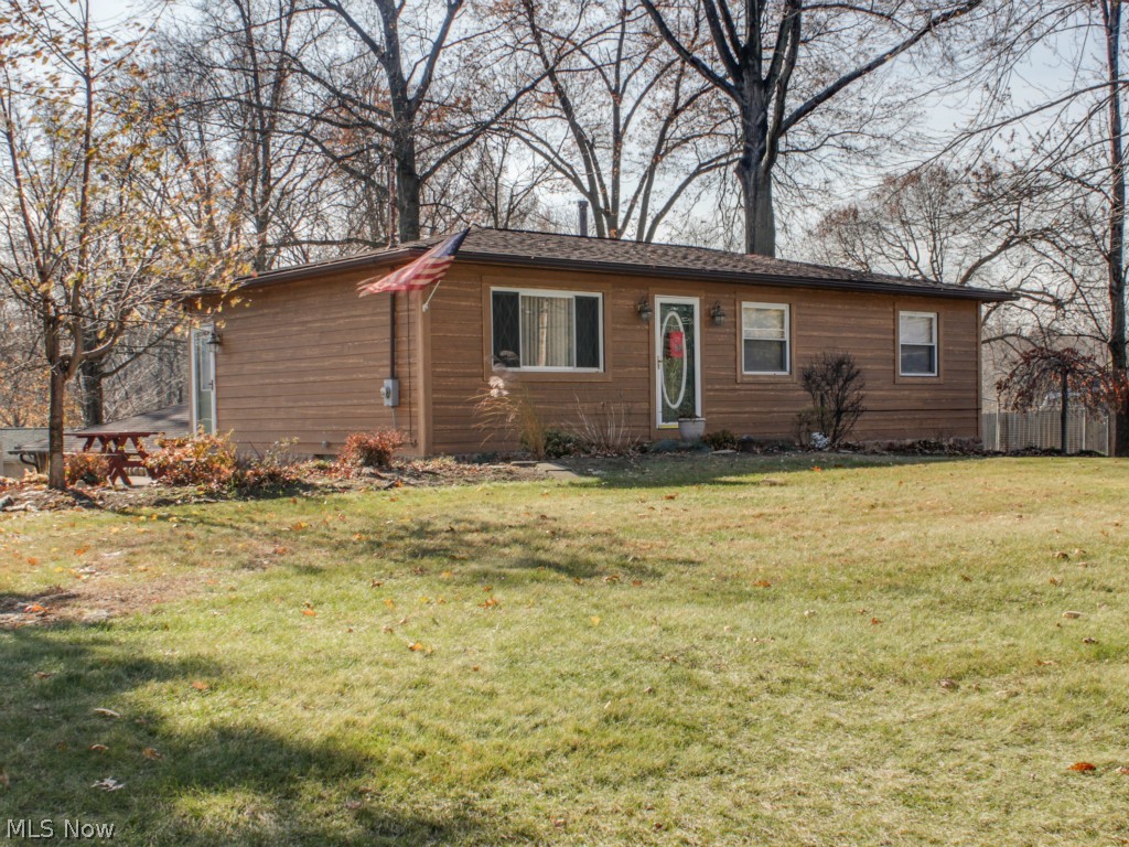Wonderful ranch, near the Lake!  3 bedroom, 2 full bath.  Bright applianced kitchen, hardwood floors, Hardie Board exterior, newer roof.  Downstairs you will find a finished walk-out basement with bar area, full bath with jetted tub and sliders to fenced in, stamped concrete patio.  Nice private lot.