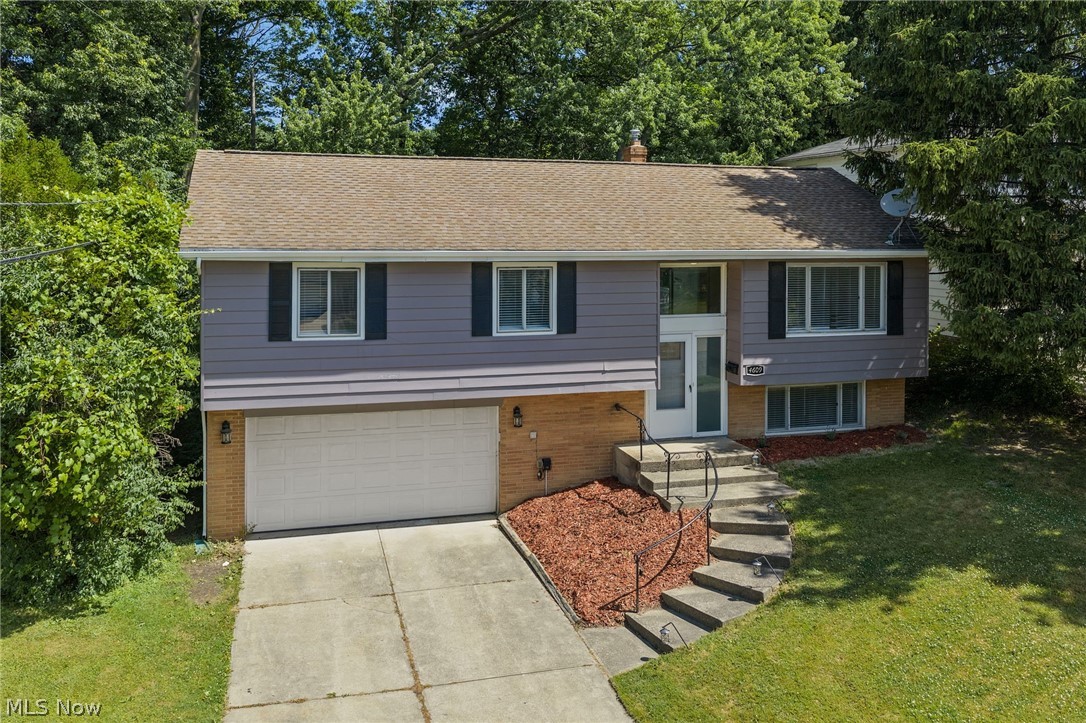 This updated split-level home offers a fully fenced-in oversized yard, attached garage, and major mechanical updates throughout. Nestled on a quiet street, the light-filled interior and beautiful backyard setting create the perfect blend of comfort and functionality.
Step inside to an inviting, light-drenched foyer that welcomes you home. Upstairs, you’ll find the spacious living room, dining area, and updated kitchen, all filled with natural light. The dining room door leads out to the deck and expansive fenced backyard featuring a lush green setting that creates a beautiful picture-esque backdrop from inside the home. The upper level also includes three bedrooms and a full bathroom. Downstairs offers an additional flexible living space perfect for a family room, rec room, office, or playroom, along with a second full bathroom, laundry room, and direct access to the attached garage. Major updates include furnace (2024), A/C (2024), hot water tank (2019), new garage door (2026), and roof approximately 12 years young. Conveniently located near shopping, restaurants, grocery stores, and Legacy Village, with quick access to the freeway for an easy commute to downtown Cleveland and major hospitals. Truly move-in ready!