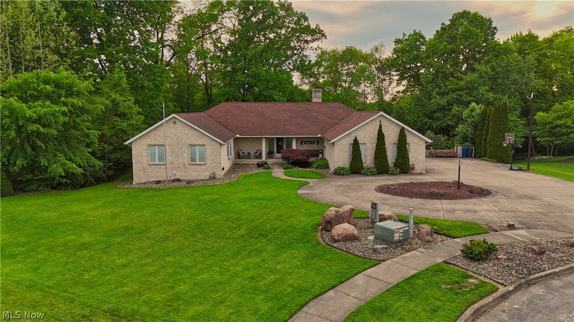 Drive to the end of the cul-de-sac and pull into this sprawling brick ranch. While you get the convenience of neighborhood living, stepping out back feels like a private retreat thanks to the 1.85-acre wooded backdrop.
Inside, the sheer scale hits you immediately. With over 3,600 square feet on the main floor alone, it offers true single-floor living. You’ll find 3 bedrooms, 3 full baths, and 2 cozy fireplaces. Need extra space? There's a dedicated office easily used as a 4th bedroom. Plus, main-floor laundry means everything you need is right on one level.
The main kitchen is an absolute chef's dream. It's loaded with high-end appliances, massive amounts of storage, and endless counter space anchored by an island with a convenient second sink—perfect for heavy prep work or hosting.
Tucked away in its own wing, the primary suite is straight out of a movie. The bedroom is massive with tons of storage, including a walk-in closet. The en-suite bathroom is just as impressive, giving you plenty of room to unwind with both a soaking tub and a shower.
Love to entertain? Head downstairs to the walk-out basement. With roughly 3,000 square feet of finished space and a full second kitchen, you can host massive holiday parties or game days without ever cluttering the main floor.
Outside, you get the best of both worlds. Walk out the lower-level doors to a quiet patio, or relax upstairs on the main deck. Thanks to the clever design and mature trees, the main-level deck is completely shielded from the neighbors next door. Sip your morning coffee in your bathrobe or host a summer cookout—your outdoor space is entirely your own.
Unmatched space, smart design, and built for entertaining. You won't find another property quite like this one.