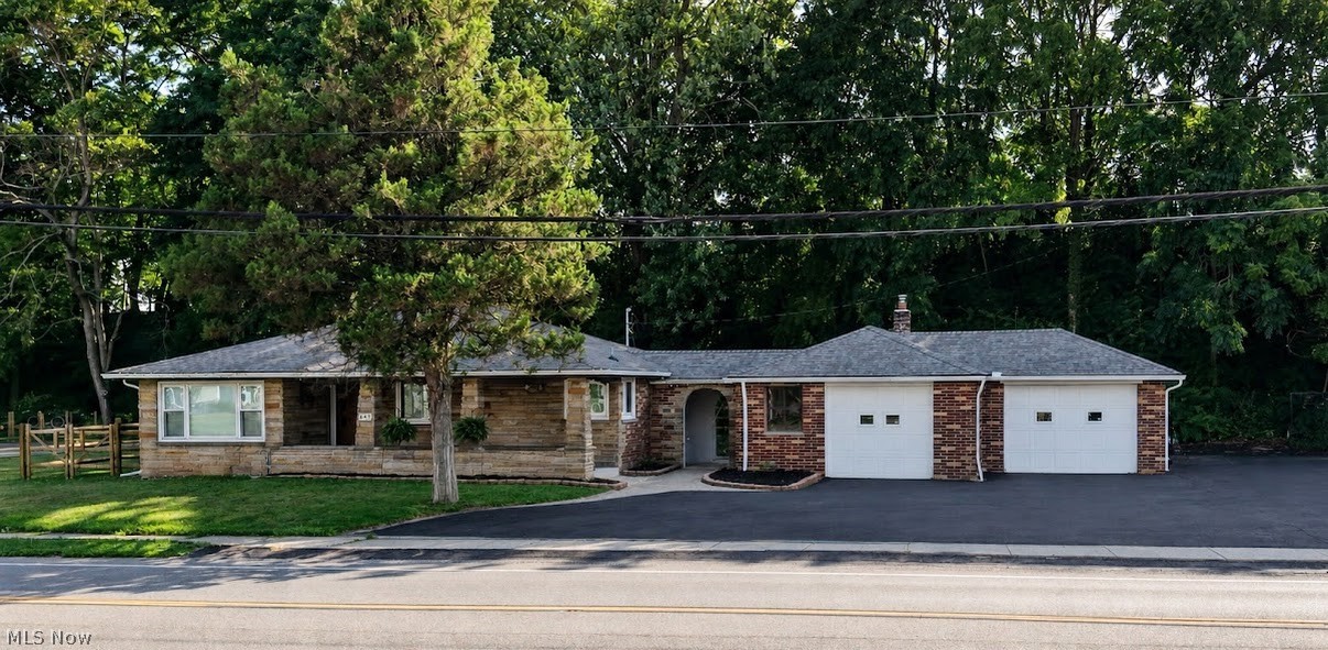 Welcome home to this well maintained 2 bedroom brick ranch that offers timeless character and everyday comfort. The spacious layout features a bright living space, a cozy dining room with built in shelving, and a kitchen with built in appliances. Original charm shines throughout while offering the perfect opportunity to make it your own with nice updates. The basement is partially finished for an option of extra living space. Outside you will appreciate the attached 2 car garage, low maintenance brick exterior, and paved driveway with plenty of parking or room to turn around. Nestled on a large fenced in lot with beautiful trees, this home provides a peaceful setting while remaining close to local amenities. Whether you are a first time home buyer or looking to downsize, this property is full of potential. Roof is from 2022, Gutters/downspouts 2024. Schedule your showing today!