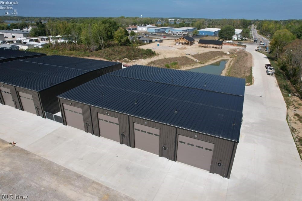 Unit C17 June 30th 2027 completion date. Adjacent side lot available! 30' x 53'. Welcome to Shoreline Storage Suites, Ottawa County's newest gated luxury storage campus. Located on Vacationland's main corridor, this new and growing storage community is accessible from the traffic light at SR-163 and SR-269N for easy entry/exit and is central to many boat ramps and campgrounds. New Root to Rise cafe and Soul Stretch yoga studio out front and the new Beach Glass Lounge is directly next door! Canoe club & wine bar is across the street. Down the street from East Harbor State Park and beach. A great place to store, work, and have fun too! Unit includes: 18'H x 14'W remote-controlled overhead door, 20+' ceilings, man door, ceiling fan, floor drain, R19 roof insulation, R13 wall insulation, interior metal walls, LED lighting, 70 AMP service, wall outlets, gas heat, plumbing rough-ins for full bathroom. Fenced-in 20' x 53' outside spaces ($26k) and optional lofts, bathrooms and other upgrades also available. Residential purposes prohibited. Triggered light at exit which is an important feature on this street during the summer season! Two sizes available: Smaller unit 23x53 - 147k. Larger unit 30x53 - 176k.
