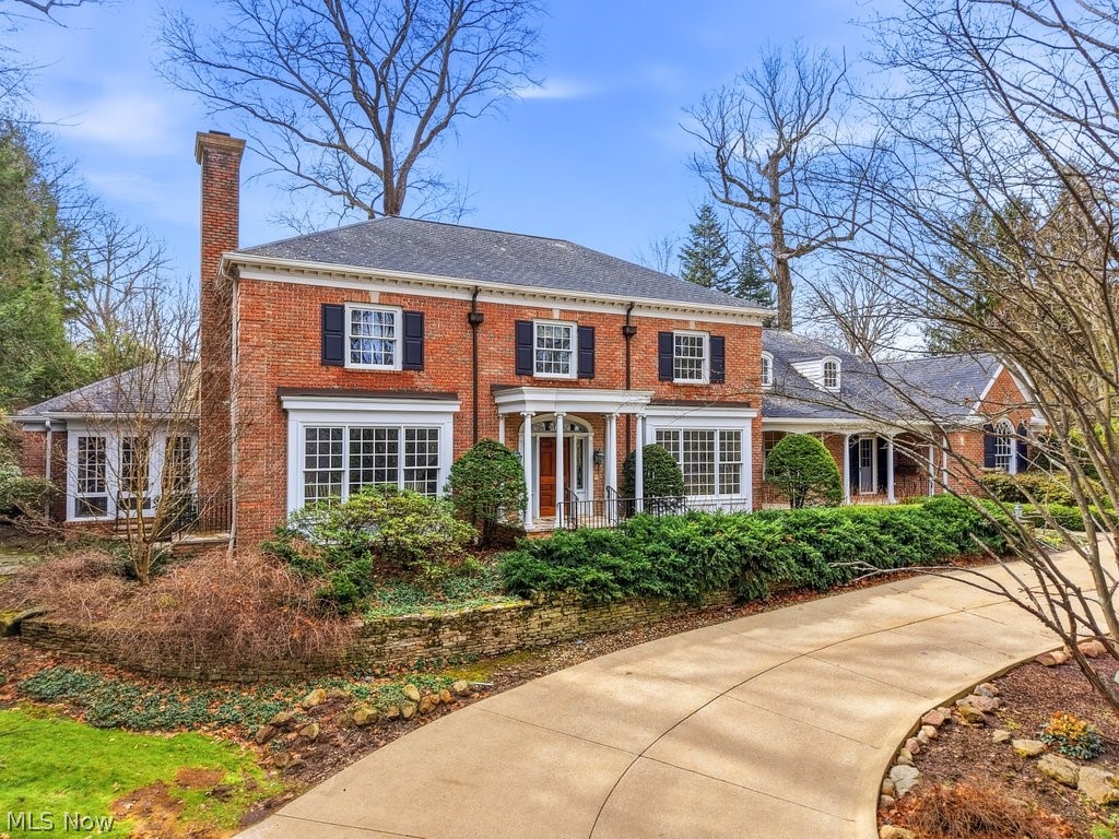 Tucked away on a quiet, tree-lined street and gracefully perched atop a hill overlooking the sought-after Fairlawn Heights neighborhood, this stately brick colonial represents one of the final masterpieces of renowned architect Phil Franz. Blending timeless elegance with the advantages of newer construction, this exceptional home offers both classic charm and modern comfort. A grand marble-floored foyer welcomes you inside and leads to the center hall where a sweeping curved staircase, spectacular crown molding & wainscoting create an unforgettable first impression. The first-floor primary suite is a true retreat, featuring dual walk-in closets, a luxurious glamour bath w/double vanities, jetted soaking tub, walk-in shower + private access to the screened-in porch. Designed with entertaining in mind, the home features two distinctive gathering spaces. The formal living room, anchored by a wood-burning fireplace, opens to the screened porch complete w/a Franklin stove - perfect for year-round enjoyment. At the heart of the home, the inviting family room showcases rich hardwood floors, custom built-ins & a fireplace w/gas insert, seamlessly connecting to the extensive outdoor terrace and the well-appointed kitchen. The kitchen is a chef’s delight, featuring solid cherry cabinets, a Sub-Zero refrigerator + a large center island w/Viking cooktop. It flows effortlessly into a cozy breakfast room, butler’s pantry, and an elegant formal dining room. Add'l main-level highlights include a functional laundry/utility room, two powder rooms, and access to both an attached two-car garage & a separate attached garage/workshop. Upstairs are four spacious bedrooms, two full baths, and an expansive storage/utility space w/shelving. Outside is the greenhouse & oversized winding driveway - partially heated and providing ample parking for your guests. This rare offering combines architectural significance, thoughtful design + an exceptional location. Truly a one-of-a-kind opportunity!