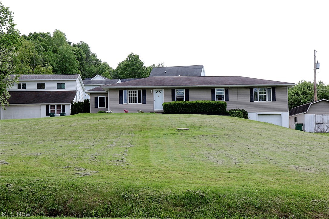 Beautiful one story warm and inviting home with original hardwood floors featuring 3 bedrooms, 2.5 baths on .75 acres. House features an attached 1 car garage with a hobby room along with a detached 2 car garage and with a heated work room and an apartment above. Kitchen updated with countertops, sink, flooring, paint, to include a gas range, refrigerator and microwave. Master is large with a sitting room/office, walk in closet and master bath. First floor laundry, new sliding back door leading to the large back deck. Updated main bath includes tub surround, sink, cabinet, toilet and flooring. Apartment includes 1 bed, 1 bath, not heated or cooled, great potential. New side door in mud room with new tile flooring and pallet wood wall.