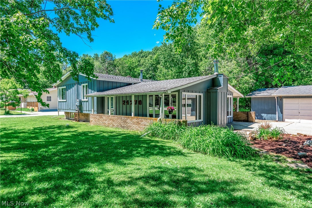 Do not miss this opportunity!  Welcome to this well-maintained 3-bedroom, 2.5-bath split-level on nearly an acre with park-like grounds and a fire pit area.  A standout feature is the 4-car detached garage, with all bays connected, separable doors, a furnace in the middle bays, and an attached storage shed—ideal for hobbies, storage, or workspace.  Inside, the home centers around a 23’ x 23’ great room with fireplace and nearly three walls of windows, combining living, dining, and kitchen in one bright open space.  New flooring and lights throughout the home.  Upstairs, the primary suite offers a 17’ x 15’ bedroom plus a 7’ x 8’ bumpout that makes a cozy reading or desk nook. Double doors give access to a 24’ covered deck spanning the home. The updated ensuite bath includes a tile shower, new vanity, flooring, and plank ceiling. The second full bath is also updated.  A second bedroom measures 17’ x 12’ with a private half bath, offering flexible living options or 2 master suites.  The lower level features a vintage-style family room with unique décor and lighting, plus a laundry/utility area with workspace potential.  A walk-up unfinished storage room adds excellent space and backyard access.  Major updates include a whole-house generator (tested weekly), furnace/AC 2024, sump pump 2022, and H2O tank 2012. Most appliances are newer, and a lower-level fridge and deep freezer are included.