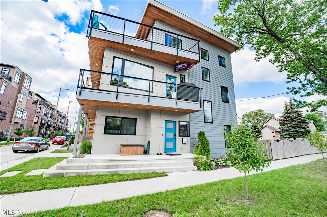 Chic, modern style softened with warm wood tones give this 2 year old home an amazing vibe; with 13 years of tax abatement remaining. It is an exciting time to live in this energetic Duck Island neighborhood. It's a small neighborhood with a great community feel that is sandwiched between downtown Cleveland, Tremont and Ohio City. Put on your shoes and walk to just about anywhere with ease! The layout and design of this home are truly unique. The first floor offers great guest/office space with 2 bedrooms and a full bath. Entertaining on the 2nd floor main level is a dream come true thanks to the natural light, open concept layout and a beautiful custom kitchen. Upstairs, you can thrill your guests on the 3rd floor deck with views of downtown or lounge inside next to a custom bar and beverage fridge. When you're ready to turn in for the night, you'll find solace in your private master bedroom, large walk in closet and ensuite bathroom.  Also upstairs is a fourth bedroom that can be use