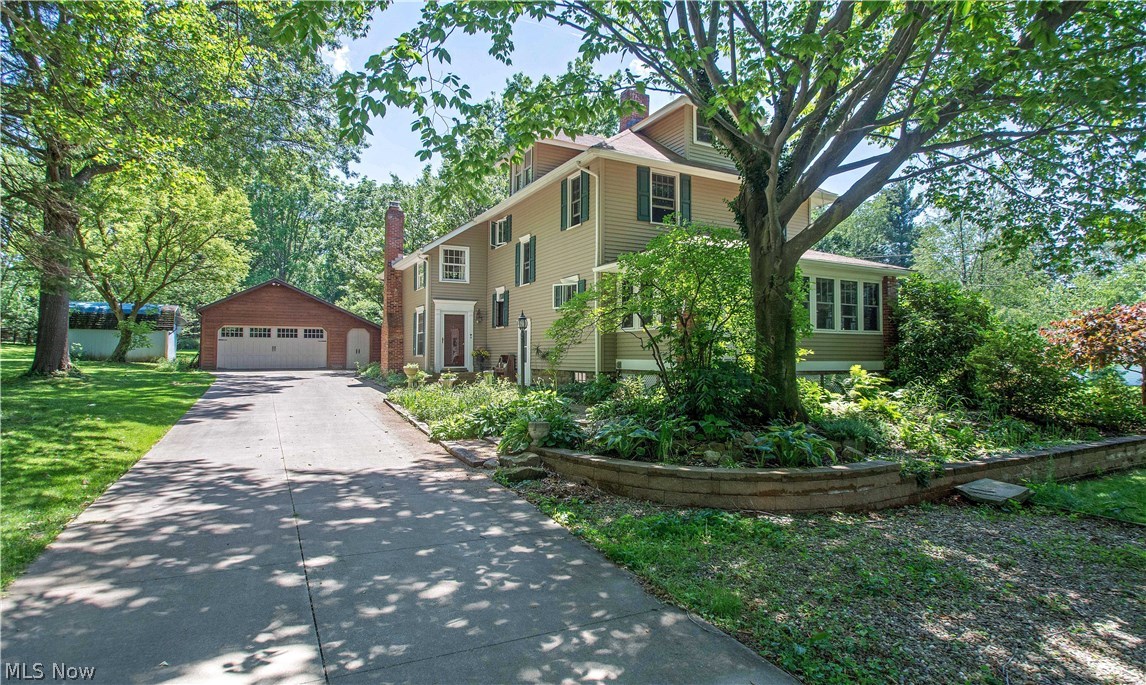 Welcome to this warm and inviting 4 bedroom, 2 bath colonial full of beauty, character and charm on a park like setting.  The inviting front porch will make your family and guests feel right at home.  The woodwork throughout is awesome!  A freshly painted and updated kitchen with cherry cabinets offers newer appliances and ample counter space for meal preparation.  Entertain easily with both a living room and fireplaced family room plus a formal dining room with gorgeous built-ins, hardwood floors & trayed ceiling.  There are sliders off the family room to the lovely deck (there's even natural gas hookup for a grill available).  The spacious master bedroom has been freshly painted, has great closet space, sitting area & connects to a full bath.  The other 3 bedrooms are good sized also.  Other updates include new roof (Aug 2017), waterproofed basement (approx. 2007); siding & front porch windows (2008); garage door (2016).  The large workshop in the basement and a 4 car garage and wood