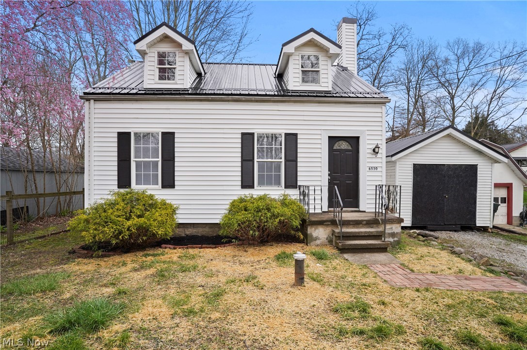 Welcome to this charming, updated Cape Cod home close to Brady Lake in Kent! Upon entering, you're greeted with sunlight streaming through the windows into the living space and onto the refinished hardwood floors. The adjacent kitchen showcases modern appliances, white shaker cabinets, and beautiful butcher block countertops. A full bathroom completes the main level, featuring contemporary fixtures and impressive subway tile. Upstairs you'll find two nicely sized bedrooms. The first bedroom boasts darling built-ins, large windows and hardwood floors. The second bedroom offers versatility, ideal for guests, a home office, or a cozy den.  Venture downstairs to discover the partially finished basement, a versatile space. Whether utilized as a recreation room, home gym, or additional storage, this area adds valuable square footage to the home and adapts to your lifestyle needs. Other updates include: brand new black metal roof on the home and storage shed, as well as, a brand new electrical panel and updated plumbing throughout. This Cape Cod home combines modern amenities with classic charm, offering a comfortable and stylish retreat to call your own. Don't miss the opportunity to make this delightful property your new home!
