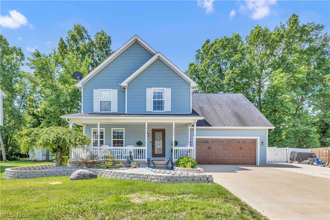Stunning 4-bedroom, 2.5-bath Colonial nestled on a cul-de-sac street located in Carlisle Township and the sought-after Midview School District. Enjoy the perfect balance of peaceful country living while remaining just minutes from OH-10, Chestnut Commons, downtown Grafton, shopping, dining, parks, and everyday conveniences. Exceptional curb appeal features an extended driveway, 2 car attached garage with updated door, covered front porch, updated front door and refreshed landscaping. Inside, this move-in-ready home showcases modern farmhouse style throughout with neutral paint colors, crown molding, updated trim, stylish light fixtures, and newer flooring. The inviting main level offers a spacious living room complete with a custom feature wall and built-in storage. The updated eat-in kitchen features beautiful gray cabinetry, granite countertops, tiled backsplash, updated appliances, and contemporary lighting. A convenient half bath completes the first floor. French doors provide direct access to the backyard retreat while filling the home with natural light. Upstairs, you'll find four generously sized bedrooms, including a spacious primary suite with a walk-in closet and remodeled private bath featuring a walk-in shower. A second full hall bath and convenient second-floor laundry room complete the upper level. The partially finished basement provides additional living space ideal for a recreation room, home office, workout area, playroom, or media room, while the unfinished section offers abundant storage. Step outside and discover your own private oasis! The fully fenced backyard features a newer white vinyl privacy fence, paver patio, expansive deck, and heated above-ground pool, creating the perfect setting for outdoor entertaining, family gatherings, and peaceful evenings at home. Additional highlights include a one-year home warranty for added peace of mind and numerous updates throughout. This home truly has it all. Schedule your private tour today!