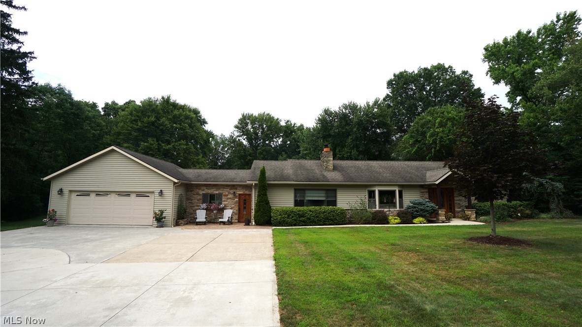 Set on a private, wooded site in Franklin Township, this beautifully renovated ranch offers refined comfort, standout design, and an exceptional resort-style backyard. The outdoor setting is designed for effortless entertaining, featuring a heated in-ground pool with slide, a spacious patio, and an inviting deck surrounded by mature landscaping. Out front, stone accents add timeless curb appeal, while a winding walkway leads to a stamped concrete patio and charming Craftsman-style front porch. Inside, the home blends warmth and sophistication with rich medium-brown laminate flooring, a striking rustic stone gas fireplace, and a seamless layout tailored for everyday living and memorable gatherings. At the heart of the home, the chef’s kitchen impresses with a dramatic 9 1/2' x 4 1/2' island offering generous storage, seating for five, and a gas cooktop, all complemented by Cambria granite countertops and premium stainless steel Thermador appliances, including a range hood, refrigerator, dishwasher, double wall oven, and drawer microwave. A built-in dry bar perfectly connects the living room, kitchen, and outdoor entertaining spaces, while the adjacent formal dining area comfortably hosts larger gatherings. A functional mud/laundry room with ceramic tile flooring is conveniently located between the kitchen and oversized three-car garage, which also offers overhead and attic storage plus a built-in workshop. A character-rich office with cathedral ceilings and hardwood floors pays tribute to the home’s original charm. Tucked away down a private hallway are three bedrooms, two updated full baths, and a spacious recreation room with sliding door access to the deck and pool. A bonus room reimagined as a generous walk-in closet adds versatility and abundant storage. Completing the package, a Heil HVAC system was installed in late September. This is a rare opportunity to own a thoughtfully upgraded home with the feel of a private retreat—schedule your private showing today.