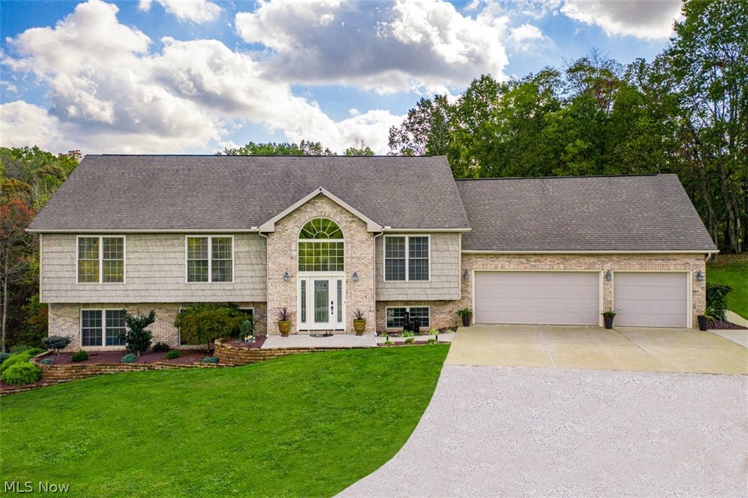 Town and Country location offers three acres of tranquility. This modern efficient floor plan has 3700 square feet of like new condition throughout. Handsome hardwood flooring leads to beautiful rooms complimented by an abundance of natural light and oversized windows that provide views of the meadow and woodlands. Multi level entry is inviting with palladium window and open staircase. The living and dining rooms are relaxed and casual. Gourmet style kitchen features furniture quality cabinets, quartz counters, professional stainless appliance package with dual fuel range, subway tile backsplash and walk out to an arbor covered raised 13x26 deck for dining. There are four bedrooms, three full baths and the 16x20 master is an ensuite. The home office could be a fifth bedroom. Lower level fireside family room with built-ins opens to13x26 covered patio and private wooded back. Laundry room is well planned with handsome hickory cabinetry, a folding area, industrial clothing rack, quartz co