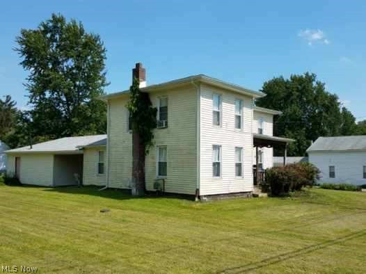 This home built in 1877 will take you back in time! It is in the middle of Amish Country and has all the essense of Country Life and simple living. Horses and Buggies travel these roads and frequently pass this home! No sounds of a busy highway or even a train. It is Nature all the way! 3 bedrooms up and the down stairs Parlor was used as a bedroom. Large kitchen and huge first floor laundry. Roof approximately 6 yrs old and the back deck about 4 yrs old. Newer windows, 2car garage and 0.50 acre lot to plant your garden. Bring your imagination and decorating ideas to make this your home.  Public water and home is currently ready for City Sewer hook up from street to house.