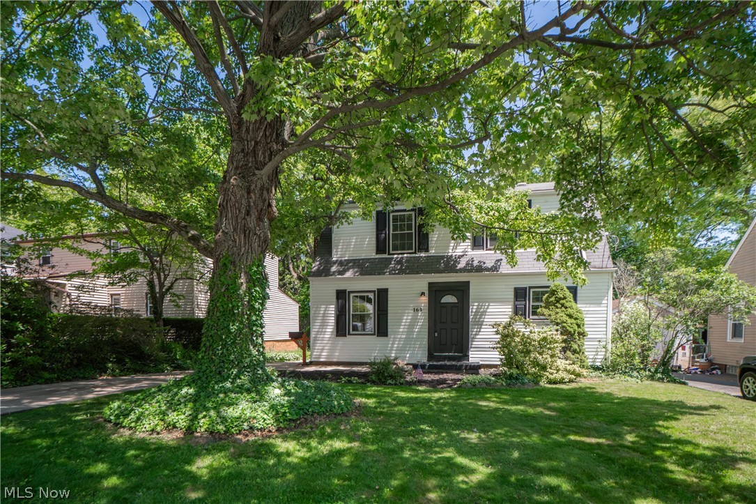 Full of warmth, charm, and thoughtful updates, this adorable Akron Colonial is the kind of home that feels inviting from the moment you arrive. Mature trees, lush greenery, and a fenced backyard create a peaceful setting, while the stone paver walkway, patio, and detached garage add both character and function. Inside, the home opens into a bright and comfortable living room where fresh finishes, natural light, and a wood-burning fireplace create a cozy place to unwind. The living space flows beautifully into the renovated kitchen, featuring crisp cabinetry, new stainless steel appliances and a center island with breakfast bar seating—perfect for everyday meals, casual conversation, or gathering with guests. Around the corner, the dining room offers its own defined space with backyard access, making indoor-outdoor living easy. A main-level bedroom and beautifully updated bath with tiled shower provide convenience and flexibility. Upstairs, a spacious loft offers a relaxing second living area, office space, or playroom, along with two additional bedrooms and another stylish bath with a soaking tub/shower combination. The unfinished lower level includes laundry, utility space, a large sink, and bonus storage. Outside, enjoy a private fenced backyard with room to relax, garden, entertain, or simply enjoy the quiet. With updated finishes throughout, comfortable living spaces, and a charming yard, this home is move-in ready and easy to love!