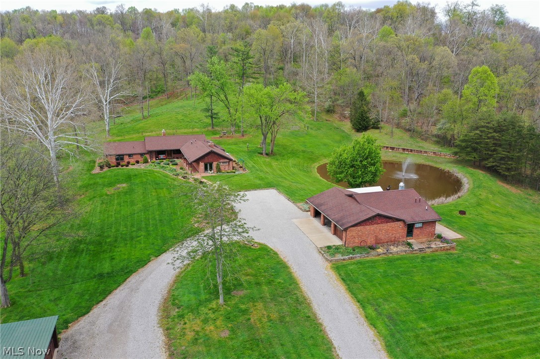 Extremely well kept 3-bedroom brick ranch home on 23.6 park like acres. 3 car detached garage with commercial kitchen and rest room attached. 32x48 shop with 3 overhead doors, water & heat. Wood sided 24x36 equipment barn. 25x41 horse stable with water & electric, 2-12x12 stalls, tack room, horse wash. Fenced pasture. Stocked pond. Secluded private location. Annual taxes are $3689.84.