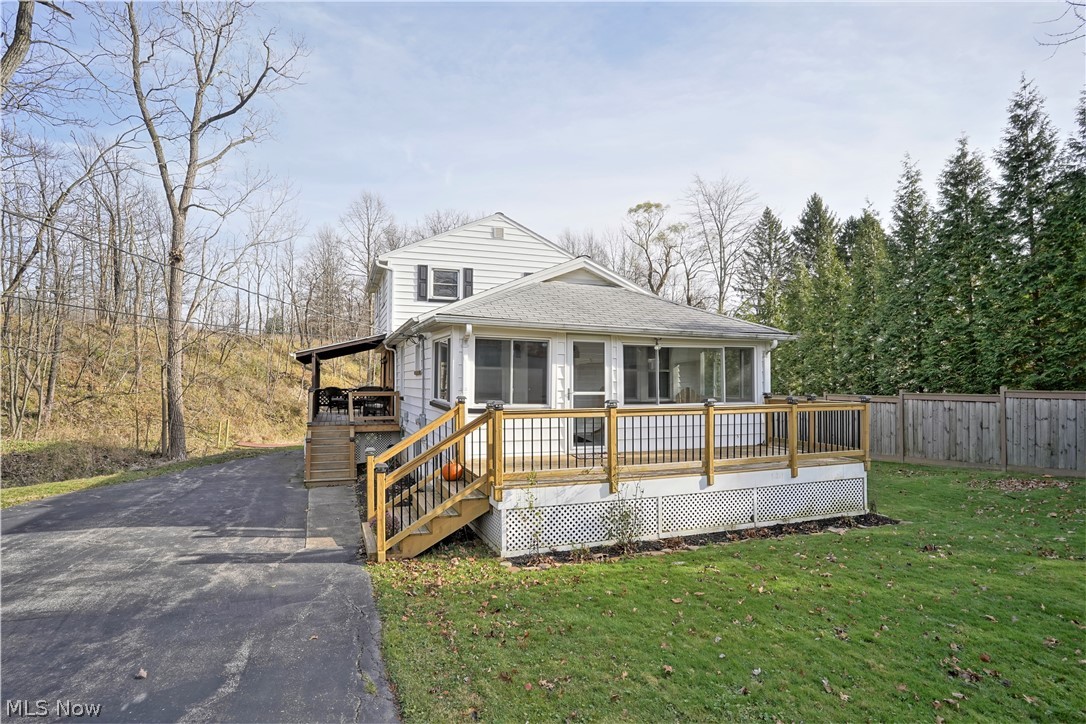 Looking for all the nature lovers! Take a look at the self guided tour in the link above!   Nestled along a gently sloped hill and creek, and away from the road, this adorable home has all the wildlife that comes along with owning a nearly 3 acre wooded property.  The home features 3 bedrooms, plus a bonus area (office? playroom?), and an enclosed porch. This has all the "feels" of the modern farmhouse, and is ready for the new owner. Current owners have an opportunity to move closer to family, and are leaving this slice of paradise in the city. With decks on 3 sides of the home, you can always find a place to sit and enjoy the tranquility.  The back yard has a little bridge to cross the creek to take you to the other side of the property.  Up over the hill is a flat couple acres ready for your own ideas.  Newer items include the septic system, windows, AC and more.