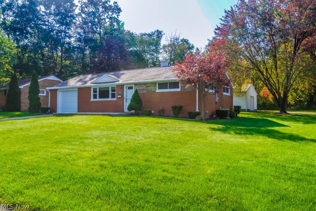 Beautifully maintained 2 bedroom brick ranch filled with updates and an outbuilding! Perfect for a hobbyist workshop or even as a space for family gatherings, the 24x30 outbuilding features a 1-car garage door that opens to a heated, insulated workshop with cabinet space, concrete floor, drywall, electric, water and a pull down ladder for attic storage! Inside, this home has been meticulously thought-out to include convenient features such as an outlet in the cleaning closet to charge the sweeper. The spacious living room boasts a picture window and new carpet. Gorgeous eat-in kitchen offers granite counters, stainless steel appliances, gas range, garbage disposal, cabinets with pull out drawers, tile flooring, a brushed nickel faucet with sprayer and a pantry! Down the hall, both bedrooms have ceiling fans and hardwood floors under the carpet. The full bath has tile flooring, an updated vanity and linen closet. Waterproofed, drylocked and freshly painted full basement has glass block