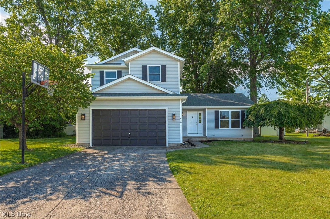 Welcome to this beautifully updated 3-bedroom, 2.5-bath home located in Lorain with the highly sought-after Amherst School District! Situated on a spacious lot in a quiet cul-de-sac, this property offers the perfect combination of modern updates, functional living space, and an incredible backyard setting. Built in 1987 and featuring a two-car attached garage, full basement, and main-level laundry, this home checks all the boxes.
Step inside to discover soaring ceilings, an open and airy layout, and stylish finishes throughout. The remodeled kitchen features stainless steel appliances, abundant cabinetry, updated fixtures, open shelving, and flows seamlessly into the dining area and family room. The sunken living room offers a cozy fireplace and sliding glass doors that bring in natural light while providing easy access to the outdoor living space.

Upstairs, you'll find three generously sized bedrooms, including a spacious primary suite with a private full bath. The unfinished basement provides excellent storage and endless potential for additional living space, a home gym, recreation room, or workshop.

The true showstopper, however, is the backyard. Mature trees provide shade and privacy while the oversized yard offers room to entertain, play, garden, or simply enjoy the outdoors. Whether you're hosting summer cookouts on the deck, gathering around a firepit, or watching the kids and pets roam freely, this outdoor space is a rare find and one of the property's most desirable features.

Conveniently located near shopping, dining, parks, and major highways, this move-in-ready home offers the best of both worlds—Lorain taxes with Amherst Schools. Don't miss your opportunity to make this one your own!