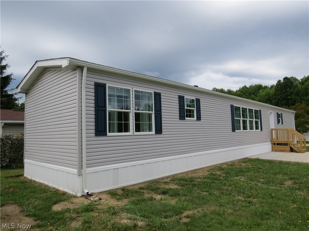 New construction single-wide manufactured home offering 3 bedrooms and 2 full bathrooms. 1140 sqft. Open-concept layout enhanced by added windows for abundant natural light. The spacious primary suite features carpet, ceiling fan, walk-in closet, and a private bath with walk-in shower and extra window. Bedrooms #2 and #3 are carpeted as well.  LVT flooring in Kitchen, Dining Area, both bathrooms, hallway and laundry area. Functional hallway desk area is ideal for home office or study space. Kitchen includes stainless steel appliances—gas range, refrigerator, microwave, and dishwasher. Home comes complete with drape package and 2” mini blinds throughout. Forced air furnace and central air included.