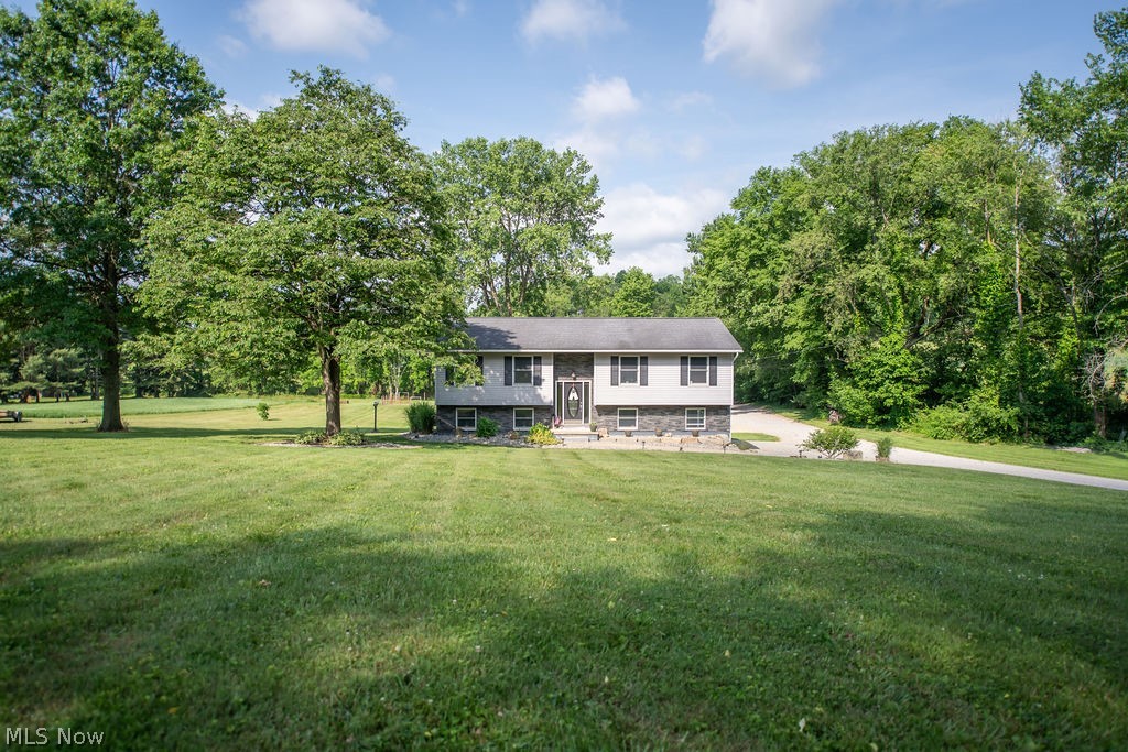 Country Living Meets Endless Possibilities!  Welcome to this beautifully maintained and recently updated country property conveniently located near Tusky Valley Schools. Offering the perfect blend of comfortable living, functional space, and hobby farm potential, this versatile property is ready for its next owner.  The home features 3 bedrooms, 2.5 baths, a spacious living room, kitchen with dining area, lower-level family room, office, oversized laundry room, and attached garage. Recent updates throughout provide a fresh, move-in-ready feel, while the low-maintenance vinyl exterior adds lasting curb appeal.  Step outside from the dining area onto the newer Trex deck, the perfect place to enjoy your morning coffee, entertain guests, or take in the peaceful country views. Below, you’ll find a private patio, creating additional outdoor living space for relaxing and gathering with family and friends.  Outside is where this property truly shines. A massive detached garage measuring approximately 32’ x 32’ with an additional 32’ x 12’ bay and its own half bath offers endless possibilities for mechanics, contractors, hobbyists, car enthusiasts, or small business owners. An additional workshop building provides even more dedicated workspace and storage.  Animal lovers will appreciate the barn complete with a wash bay, along with a pasture area ideal for horses, livestock, 4-H projects, or hobby farming. Whether you’re dreaming of a mini farm, a place for your equipment and recreational toys, or simply more room to enjoy the outdoors, this property delivers.  Offering a rare combination of a well-maintained home, updated interior, Trex deck, private patio, oversized detached garage with half bath, workshop, barn, and pasture—all in a desirable Tusky Valley location—this property is packed with opportunity.   Bring your animals, hobbies, tools, and dreams—this one has room for it all!