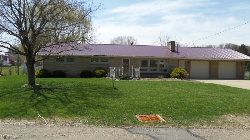 Beautifully updated 3 Bedroom, 2 Full Bath Brick Ranch, metal roof, custom window treatment. newly refinished kitchen, family room and living room both have a fireplace, dining room, laundry room, central air, 2 car attached garage,concrete drive, brick patio off family room w/wooden deck, outbuilding, walking distance to schools, on almost an acre.