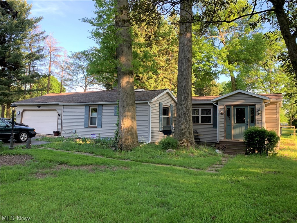 Feel like you're in the country on the 2.78 acre parcel located near the Eastwood Mall.  Darling ranch with large living room, eat-in kitchen with vaulted ceiling, 2 bedroom, 1 bath and laundry room.  Large heated attached garage!  This home has been well maintained with updates galore.  Done in the last ten years: completely updated kitchen and bath,  furnace, a/c, hot water tank, roof and windows.  Home also has newer vinyl siding and newer vinyl tilt in windows. All this with a One Year Home Warranty for your piece of mind.   So, what are you waiting for... schedule your private showing today!