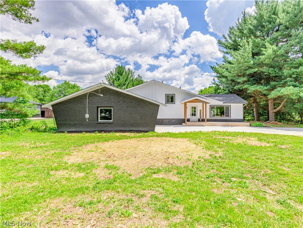 Completely renovated from top to bottom, this stunning split-level home offers the perfect combination of modern style, functional living space, and room to roam. Situated on a beautiful 5 acre lot, this move-in ready home features 3 spacious bedrooms, 2 updated full bathrooms, an attached 2-car garage, and a barn with electric and water, along with a set-up for electric fence. Step inside to an impressive open-concept floor plan with soaring vaulted ceilings, abundant natural light, luxury vinyl plank flooring, and a spacious living room designed for everyday living and entertaining. The gorgeous chef's kitchen features gray shaker cabinetry, stainless steel appliances, expansive countertops, a large center island, and sliding doors leading to a deck overlooking the peaceful backyard. The lower-level family room offers additional living space centered around a striking floor-to-ceiling stone fireplace, creating the perfect spot to gather year-round. Generously sized bedrooms feature fresh carpeting, ample closet space, and updated finishes throughout. Both bathrooms have been beautifully remodeled with modern fixtures and stylish finishes. Outside, enjoy the privacy and flexibility of over an acre of level yard surrounded by mature trees, along with a spacious outbuilding that offers endless possibilities for storage, equipment, or a workshop. Additional updates include a new concrete driveway, fresh exterior improvements, updated flooring, lighting, paint, kitchen, bathrooms, and more. This turnkey property combines modern updates, spacious indoor and outdoor living, and a desirable setting that's hard to find. Schedule your private showing today before this exceptional home is gone