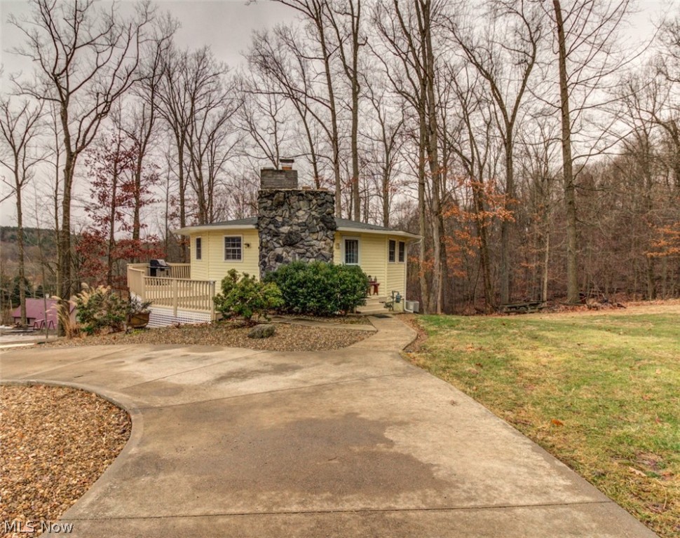 Take a look! Stunning & very unique renovated round house with great curb appeal situated on three lots, a little over an acre of property! Buy now & plan a perfect weekend retreat or live here full time. Tucked away on a quiet street you'll find an open floor plan and vaulted ceilings that gives this home great character. Awesome stone electric fireplace adds much charm. Lake Mohawk is a gated community having a 500 acre lake with unlimited horsepower, three beaches, clubhouse, golf course and tennis courts. Lake Mohawk is located 45 minutes southeast of Akron & 25 minutes from Canton. Enjoy fishing, boating and so much more.