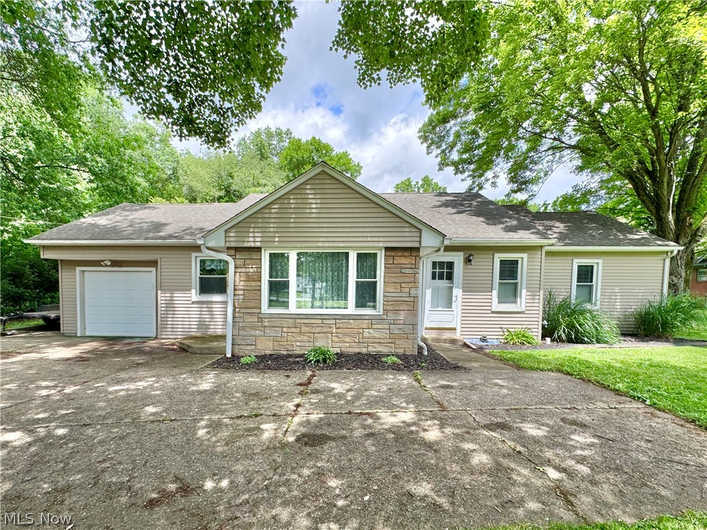 This Boardman Ranch is the perfect place to spend your summer. Relax in the huge inground pool surrounded by just over an acre of nature. Recently updated and ready for a new owner, this home has so much potential. As you enter into the living room you will notice its character with gas fireplace and built-in bookcase, step through the arched opening to dining area with built-in cabinet and through to the kitchen equipped with oak cabinets, new stainless steel appliances and tile floor. From here you enter to the rear family room with huge windows overlooking the pool and backyard. Down the hall are the main bath, two generous sized bedrooms, the owners retreat with ensuite bath and exterior door to access the back patio and pool area. There is an additional flex space with separate exterior access that could be used for a home office or bedroom 4. Partial basement is home to the laundry, and plenty of storage, there is a one car attached garage and a large concrete driveway with plenty of parking. Roof, windows and siding 10 years old. Pool liner and cover 2025.