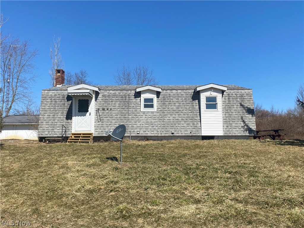 With a click of your shiny, red shoes, a real sense of security could be yours! The long driveway leads to the house, which sits on over 5 acres. With reinforced walls, the main floor has plenty of living space including a mudroom, half bath, eat-in kitchen, open dining area, living room, & a family/bonus room. The extremely wide and steel enforced stairs lead down to a fully finished basement. Down under lies the 3 bedrooms, full bath, laundry/utility room, as well as a spacious storm shelter area under the stairs to ensure occupants’ safety, letting everyone feel brave. The property hosts 3 over-sized garages, which could potentially hold between 6-8 vehicles, an animal coup straddling a stream, and a picnic shelter for fun and entertaining! Yet, the quick access to Route 40 makes shopping accessible and easy commutes possible. Amid farms and woods, lies privacy and country living at its finest. Plenty of flat land lends to great animal area options, and still allow gardening galore.