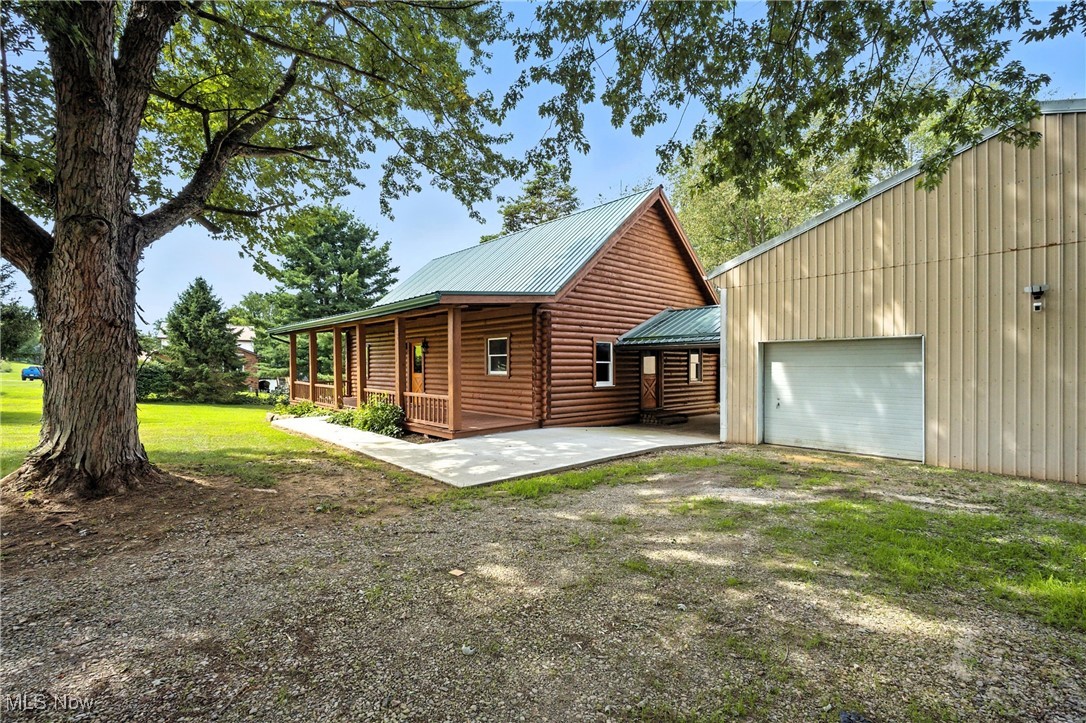 This property is not for rent, but you may think of it as a summer rental.  Discover this dream retreat featuring a beautifully updated 1821 sq ft log home, plus a huge garage and a 1-bedroom apartment, all situated on 5 serene acres at 57218 Somerton, Barnesville, OH.  Inside, you will find an updated kitchen with quartz counters, new appliances, expanded kitchen cabinets, and a beautiful breakfast bar. An updated bath with a walk-in shower, new vanity, and soaking tub will be for your pleasure.. New LVT flooring  spans the entire first floor, complemented by a newly cedar-lined closet in the first-floor bedroom and plush new carpet in the cozy loft. The home's exterior has been meticulously cared for with a re-stained and resealed log finish, a new porch roof, and a newer main log home metal roof, all enhanced by new concrete walks and fresh landscaping. Beyond the main residence, a massive garage offers ample space, including room for a motorhome, and features a newly built, fully equipped one-bedroom apartment with, a kitchen,  a full bath, utility room, on-demand hot water, new split system HVAC, private patio, and LVT flooring, accessible from both the garage and its own exterior entrance, making this property ideal for a potential business venture or rental income, with updated electrical systems in both the home and garage ensuring modern convenience. Schedule your private showing today!