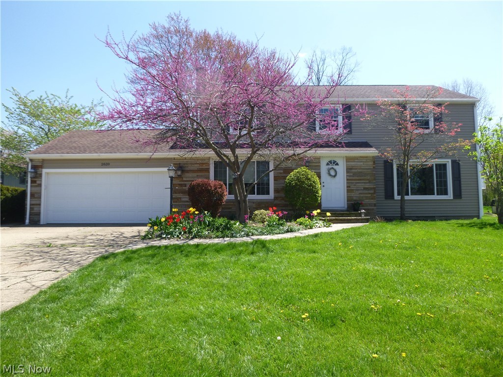 This is the beautiful and well-kept home that your family has been waiting for!  You’re greeted by a large, well-lit living room that leads to the formal dining room.  Create wonderful meals in the gorgeus eat-in kitchen that features newer stainless steel appliances, tile flooring, pantry and a ton of cabinet space.  Gather the family around the fireplace or relax with your favorite book in the stately family room.  Downstairs you can serve drinks from the bar while entertaining company in the recreation room.  A bonus room with built-in bookshelves, also in the lower level, could serve as a study.  The large master bedroom has gorgeous hardwood floors, walk in closet, and master bath with updated tile shower (2015).  The whole-house ventilation system saves you money on days when the AC isn’t quite needed.  A paradise awaits out back with privacy fence, large patio, inground pool with water slide, and wonderful landscaping.  Other updates include HE furnace (2019), roof (2010), windows (2012), gutter guards (2017), and siding (2014).  Enjoy peace of mind with 1 year of America’s Preferred Home Warranty included.  Located in Woodridge school system and just minutes from all the shopping and restaurants at Portage Crossing.  Schedule your private showing today!