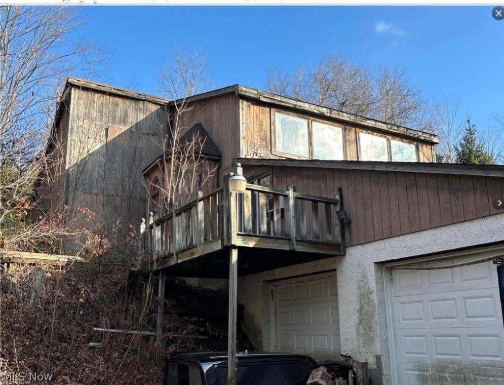 Private and peaceful retreat in Newbury Township. This home offers 1,800 sq ft of living space, scenic pond views, and a secluded setting surrounded by nature. Affectionatley called the bomb shelter (yes, it has a bomb shelter) is nestled at the end of the property for ultimate privacy. Relax on the patio overlooking the water and enjoy the privacy this unique property has to offer. Rare opportunity with character, acreage, and endless potential. Audio & video surveillance. Camera's on all points of property. DO NOT WALK/ENTER PROPERTY WITHOUT AN AGENT. Guard dogs on duty. May bite.