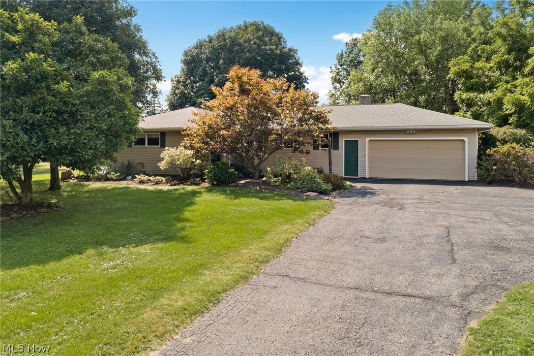 Welcome home! This ranch on over 3 acres will feel like its own slice of heaven, located in Richfield Township & in desirable Revere School District. Coming up the drive, you'll see a large storage shed, a boat/RV pad, and a 1-car detached garage with 220/50 amp service in addition to mature trees & landscaping throughout the property (including an asparagus patch)! Upon entering the home, you're greeted with newer laminate floors and an updated kitchen with a charming bay window, maple cabinetry, and stainless-steel appliances. Beautiful hardwoods run throughout all 3 bedrooms and into the main living area which features a stunning brick wood-burning fireplace, American wormy chestnut mantle & wood accent walls on either side. The sunroom is where you'll discover a relaxing setting equipped with a pellet stove, overlooking lush greenery in the backyard as well as a sizable patio. There's a full bath centrally located on the main floor and the laundry room couples with a half bath and