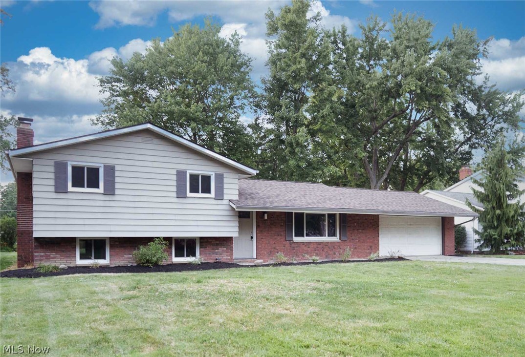 Located in Mentor's beautiful Western Reserve Estates, this spacious home offers 3 beautifully remodeled levels on its gorgeous large lot. You’ll enjoy your early morning coffee in your renovated kitchen, fully equipped with quartz countertops, and new stainless steel appliances. Both the large kitchen and adjacent dining room, overlook the lovely park like yard. A sliding door leads to the rear patio, providing beautiful space for entertaining and celebrations. The home’s upper level offers a roomy primary suite with dual closets, and en suite half bath. The remaining 2 bedrooms & a gorgeous remodeled bath with double vanity complete the upper level. All 3 bedrooms boast hardwood floors, updated lighting, fresh paint, and plenty of closet space. Downstairs a few steps, you’ll find a cozy den with a fireplace as well as another updated half bathroom. The lower level provides a fully finished flexible space that could be a home theater, home office, or gym. The large 2 car garage is freshly painted. Newly mulched gardens in the front and rear yards welcome you and your guests with peaceful surroundings. Parks, restaurants, shopping and highway access are just minutes away providing unparalleled convenience. Move right in - too many upgrades to list- new windows, new exterior doors, new roof (2025), new appliances, new mechanicals, and so much more! Call for your private showing today!