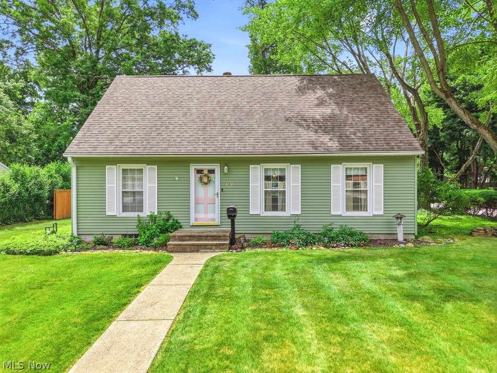 This well-maintained Cape Cod offers 1,383 sq ft of functional living space with 4 bedrooms and 2 full baths. The bright living room features hardwood floors, neutral paint, and large windows that bring in natural light. The layout flows into the eat-in kitchen, which provides ample cabinet storage, classic wood cabinetry, and a practical, easy-to-use workspace. The main level includes two bedrooms with hardwood flooring and standard closet space, along with a full bathroom conveniently located between them. The second floor offers two additional bedrooms with hardwood floors and flexible layout options. The home also includes a functional basement with a laundry area, utility space, and additional finished square footage suitable for a recreation area, storage, or future customization. Outside, the property features a large backyard with mature trees and open green space. A detached 2-car garage sits at the back of the home, offering parking, storage, and convenient access from the driveway. New roof and newer glass block windows in basement.