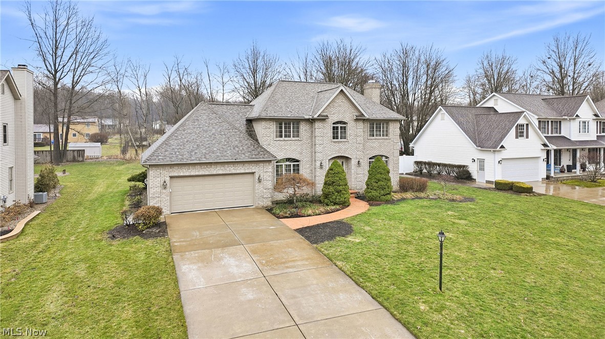 Welcome to this well-maintained, custom-built home in Howland with a brick front and custom windows. This home offers 3 large bedrooms and 2.5 bathrooms with plenty of living space.

Enter through the foyer featuring an open staircase with a wrought iron railing. The formal great room includes a gas fireplace and provides a comfortable space for relaxing or gathering. The formal dining room features crown molding, a tray ceiling, and a crystal chandelier.

The eat-in kitchen offers an island and two pantries for extra storage. A sliding glass door opens to the patio and landscaped yard, making it a great space for outdoor gatherings. Just off the kitchen, a half bath and laundry room are conveniently located.

Upstairs, the large primary bedroom includes a private full bathroom. Two additional bedrooms and another full bathroom provide space for family or guests. All bedrooms include ceiling fans and large closets.

The basement is dry, plumbed, and ready to be finished for additional living space if desired.

Updates include a brand new roof installed at the end of 2025, a security system and smart garage door technology, whole-house laminate flooring, kitchen disposal, light fixtures and fans (except in the dining room and foyer), and a furnace (comes with 12 yrs warranty on parts and labor), all completed in 2024. The 50-gallon hot water tank and microwave were replaced in 2023. The washer and dryer were new in 2020. The stove, refrigerator, dishwasher, and air conditioner were installed in 2015. 

Schedule your showing today to see all this home has to offer.