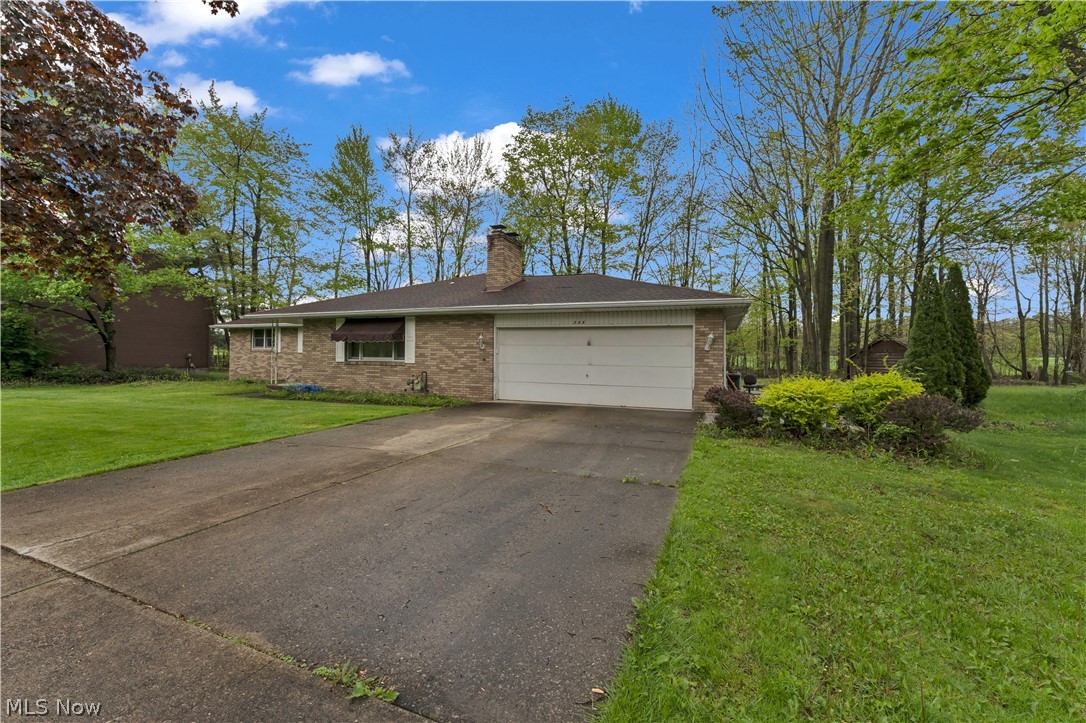 Beautiful 4-bedroom brick ranch situated on a serene wooded lot with a park-like setting. This home features stunning hickory hardwood flooring throughout the bedrooms, hallways, living room, and dining room. The kitchen, bedroom closets, and four-seasons room offer a stylish porcelain tile flooring. Enjoy natural light pouring into the spacious family room through a striking round skylight. The primary suite includes a private full bath, while the second bedroom features its own convenient half bath—perfect for guests or added privacy. The kitchen is equipped with granite countertops and rich maple cabinetry, blending both function and style. The basement adds exceptional versatility with a second full kitchen—ideal for entertaining. Step outside to the wrap-around deck attached to the four-seasons room—ideal for relaxing or entertaining while taking in the peaceful, wooded surroundings.
