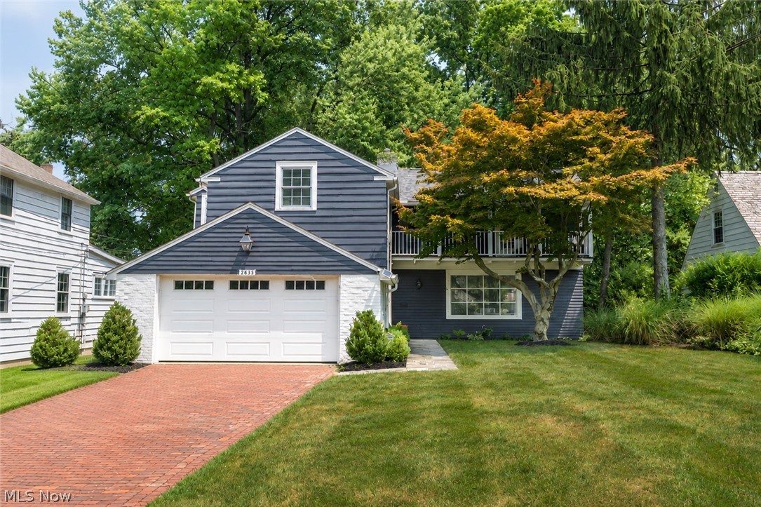 Thoughtfully renovated and beautifully maintained, this home blends timeless character with modern updates. The inviting living room with a fireplace opens to a vaulted family room filled with natural light and overlooking the professionally landscaped, fully fenced backyard. The updated kitchen features bluestone floors, marble countertops, and flows seamlessly into the dining area with French doors leading to a bluestone patio—perfect for entertaining. Upstairs, the redesigned owner's suite offers a walk-in closet and a stunning en-suite bath with double vanities, marble countertops, and a tiled shower. Two additional bedrooms share an updated full bath with double sinks and marble finishes. The finished lower level provides flexible space for a rec room, home office, or gym, plus plenty of storage. Complete with an attached two-car garage and a long list of improvements, including a newer roof, this is a home you'll want to experience in person.