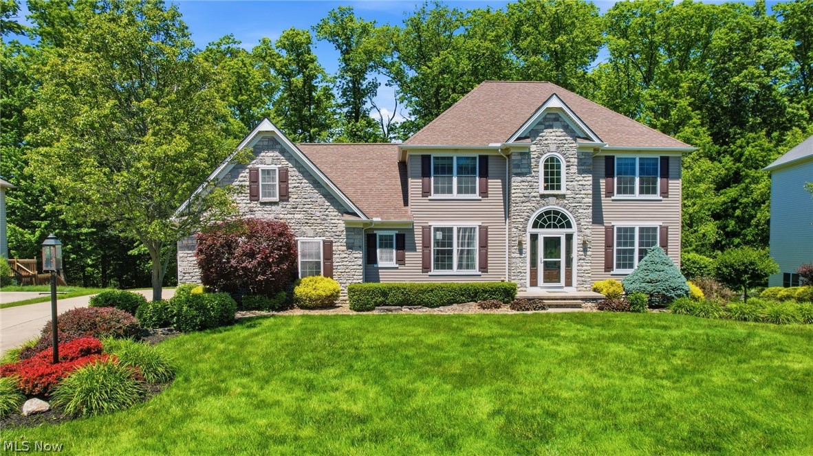 Welcome to 8255 Hemingway Lane! This beautiful 4 bdrm, 4 bth Colonial is located in the desirable Holden Ridge neighborhood of Concord Township and offers plenty of space with high end finishes both inside and out. From the moment you arrive, you'll appreciate the homes great curb appeal, mature landscaping, and private wooded setting. Inside, you'll find spacious living areas with an open concept with plenty of natural light, making it easy to enjoy everyday living and entertaining alike. The kitchen offers plenty of cabinet and counter space and opens to the main living areas, creating a comfortable layout for gatherings with family and friends. Upstairs, the large owner's suite features a private bath and walk-in closet, while the additional bedrooms provide plenty of room for family or guests. Upstairs also offers large bonus room that could easily serve as a 5th bedroom, playroom, home gym, or office, the possibilities are endless. One of the standout features of this home is the finished walkout basement, complete with a beautiful granite bar area that's perfect for game days, parties, or relaxing after a long day. The walkout design provides an extra living space and own bathroom plus easy access to the backyard and adds even more functional living space. Step outside and enjoy the peaceful backyard setting with a massive two-tier composite deck with added canvas gazebo and underneath covered shed, perfect for storage. Whether you're hosting friends, spending time with family, or simply enjoying the backyard, you'll appreciate the privacy and space this property provides. Conveniently located near shopping, restaurants, parks, and major highways while still offering the quiet feel of a neighborhood setting, this home truly has something for everyone. Don't miss your chance on this incredible property!