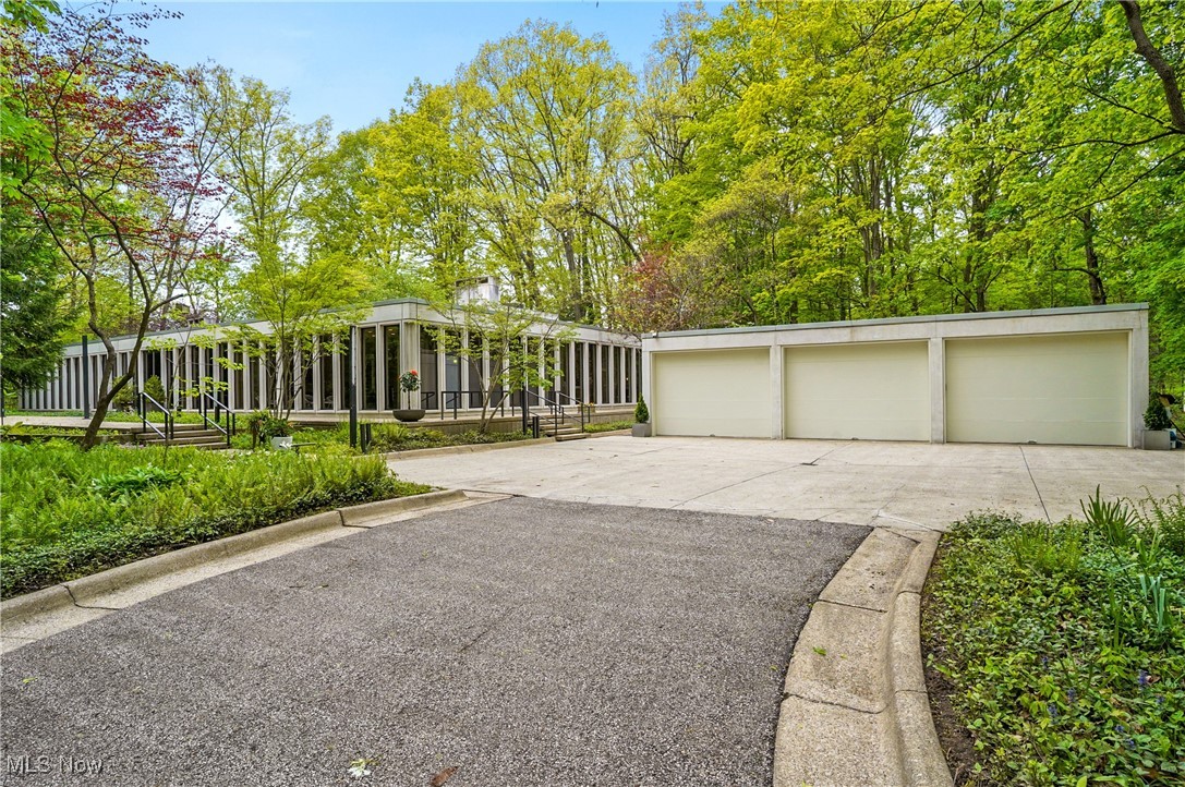 Step into timeless elegance with this stunning mid-century modern home. Built-in 1968 and designed by Harvey Stubsjoen—a renowned architect and former Mies van der Rohe student—this home is a true architectural gem. Nestled on a gorgeous wooded lot with lush, forest-like views, it was thoughtfully crafted to blend indoor comfort with outdoor beauty.

Floor-to-ceiling windows flood the interior with natural light, while a central atrium serves as a striking and unique focal point of the home. The nearly 6,000-square-foot ranch features a mirror-image design that makes everyday living both stylish and seamless.

Offering five spacious bedrooms and three full baths, the home is outfitted with well-appointed wardrobes that enhance each room’s sophisticated charm. The minimalist kitchen and living areas strike the perfect balance between architectural beauty and modern functionality.

This house is truly spectacular—don’t miss out!