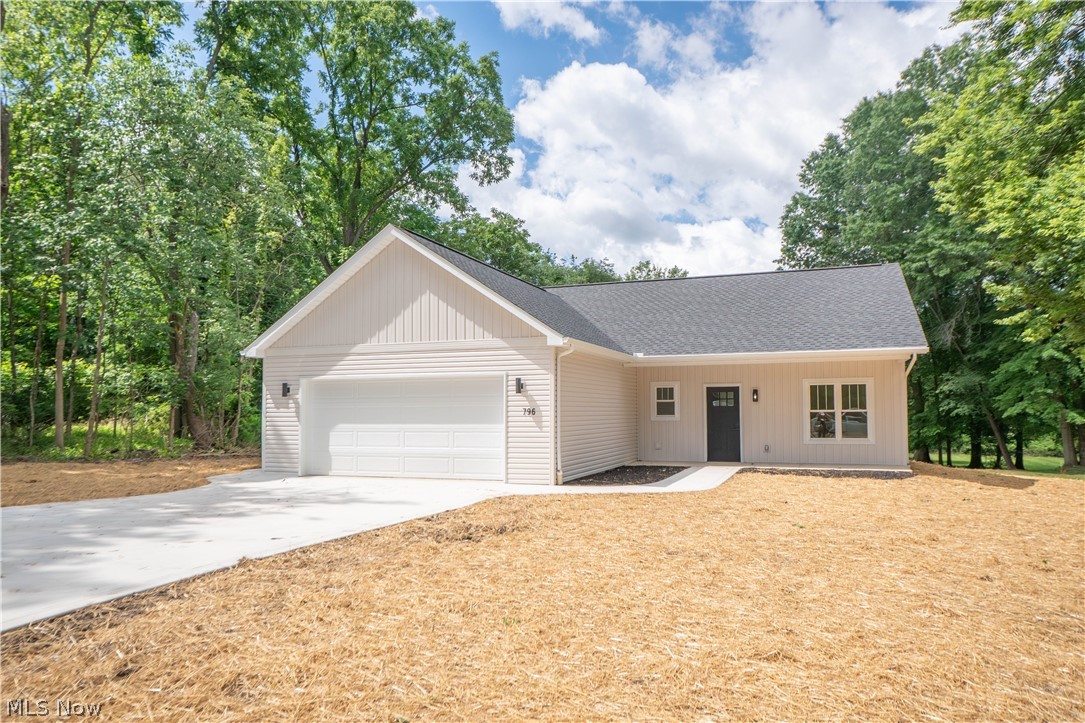 Be the first to call this brand-new 2026 ranch home your own! Set on a spacious .82-acre lot in Tallmadge, this thoughtfully designed one-level home offers modern finishes, an open floor plan, and easy everyday living from the moment you arrive. A covered front porch welcomes you inside to a foyer hallway, where the first bedroom is conveniently positioned near the entry, offering flexibility for a guest room, home office, or additional living space. Across the hall, the main-level laundry room adds everyday convenience with direct access to the attached 2-car garage. Continue into the heart of the home where the living room opens beautifully to the eat-in kitchen, creating a comfortable and connected layout for relaxing or entertaining. The kitchen features crisp cabinetry, stainless steel appliances, pendant lighting, a center island with breakfast bar seating, and a large pantry. Sliding doors off the kitchen lead to the back concrete patio, perfect for outdoor dining, grilling, or enjoying views of the spacious backyard. Just off the kitchen is a full bathroom with a tub/shower combination. Two additional bedrooms are tucked away on the opposite side of the home, including the primary suite with a private full bathroom featuring a dual-sink vanity, tiled shower, and walk-in closet. With fresh neutral finishes throughout, carpeted bedrooms, LVT flooring through the main living areas, central air, public water and sewer, and a peaceful backyard setting, this new construction home is move-in ready and waiting for its first owner!