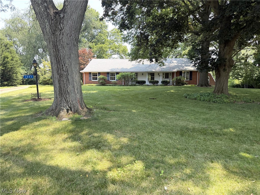 Lovely brick ranch on a cul de sac located in Avondale. This home has approximately 5,481 sf of living space and is situated on 1.04 acres and has beautiful shade trees. If you're looking for an in-law suite or if you love to entertain, this spacious home is for you! The home features four bedrooms, five bathrooms, three fireplaces and custom cherry cabinetry throughout the home. For the organizer, there's an incredible amount of storage space. The first floor features two bedrooms. One is an owner's suite with a private bathroom and the other bedroom has an attached greenhouse. Kitchen features gorgeous custom cherry cabinetry and a breakfast bar. There is custom cherry cabinetry that runs from the kitchen into the dining room. There is a  huge living room and a family room with a fireplace.  The great room has a cathedral ceiling with wood beams, built-in custom cabinetry, a fireplace and a huge built-in hot tub. There is also a sauna room and storage room off the great room.  Access the two-tier brick patio off the family room and relax and enjoy the serene backyard. The upstairs features a bonus room and a bedroom with lots of storage closets including four closets in the hallway. Access the lower level via an elevator to the in-law suite or the three other entrances to the lower level: off the great room, the garage or through the kitchen. There is an in-law suite on the lower level with a full kitchen, living room, bedroom and spacious bathroom with a huge walk-in shower and jacuzzi. The lower level also features a recreation room with a pool table area (pool table stays), fireplace and a wood shuffle board. There is a work room with work bench and built-in shelving. The two laundry rooms are on the first floor and lower level. All appliances stay. Home has a Generac system, Aprilaire system, water softener and two furnaces. Relax and enjoy the serene views from either the covered front porch or the backyard patio.